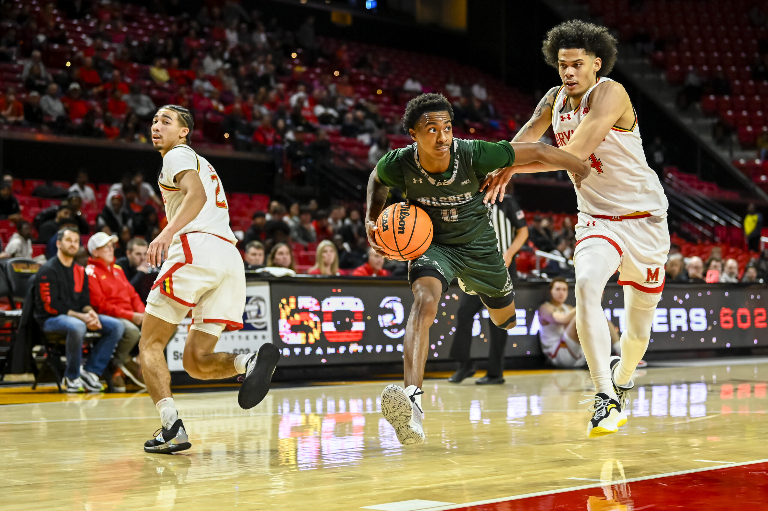 Dec 2, 2025; College Park, Maryland, USA; Wagner Seahawks guard Nick Jones (0) cuts in-between Maryland Terrapins forward Aleks Alston (24) and  guard Myles Rice (2) during the first half  at Xfinity Center. Mandatory Credit: Tommy Gilligan-Imagn Images