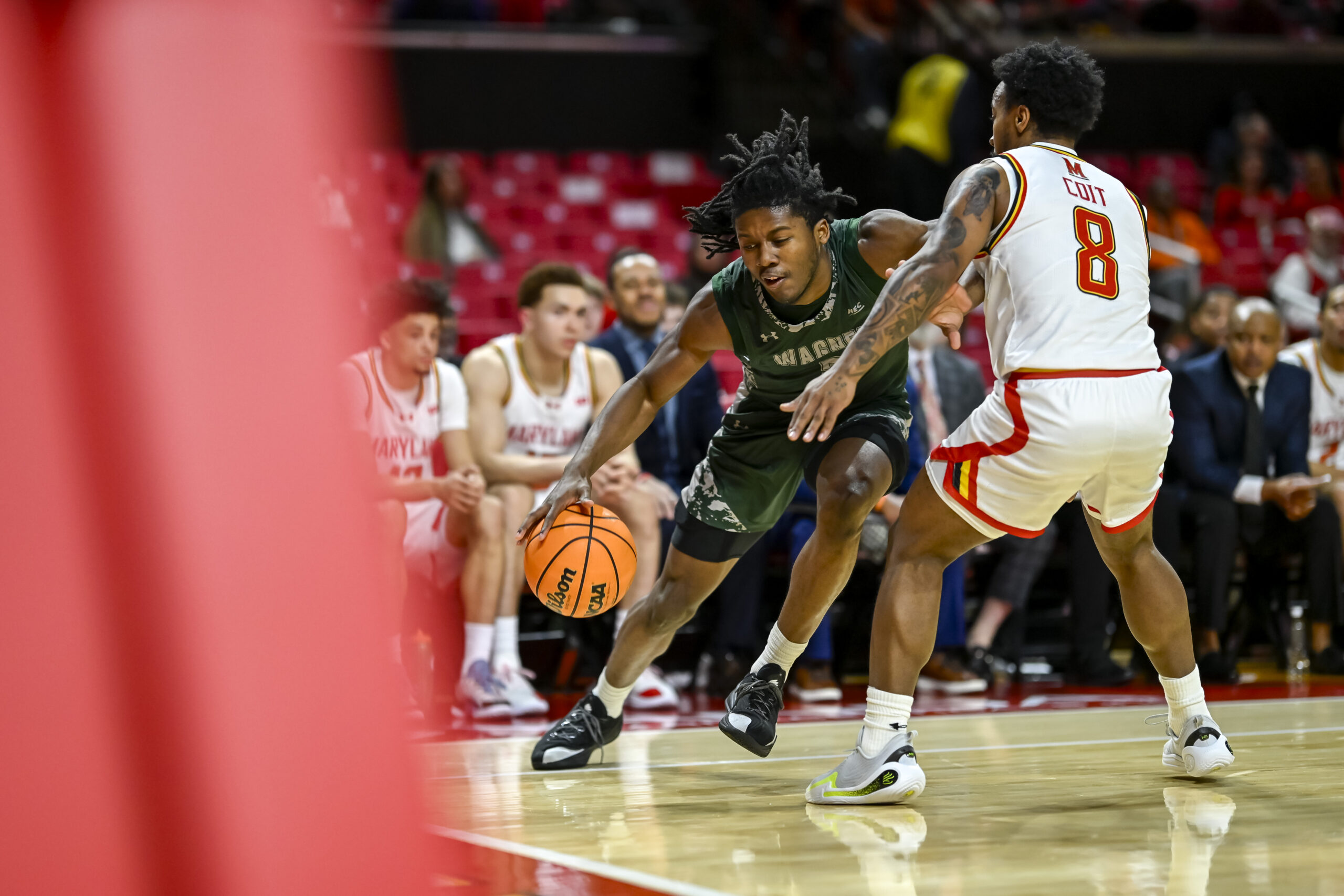 Dec 2, 2025; College Park, Maryland, USA;  Wagner Seahawks guard Michael Cooper (5) dribbles as Maryland Terrapins guard David Coit (8) defends during the first half at Xfinity Center. Mandatory Credit: Tommy Gilligan-Imagn Images