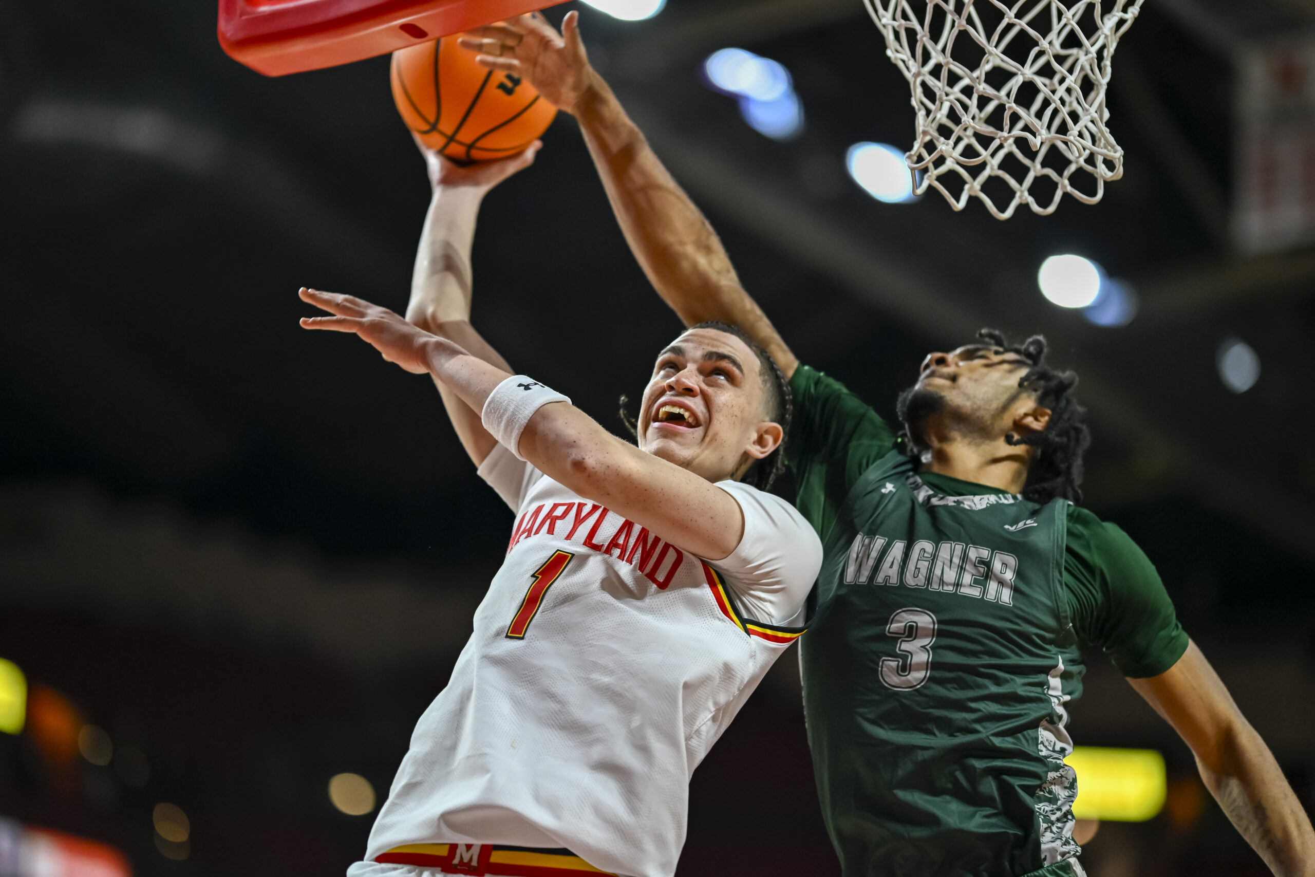Dec 2, 2025; College Park, Maryland, USA; Maryland Terrapins guard Darius Adams (1) shoots as Wagner Seahawks guard Elijah Brown (3) defends during the second half at Xfinity Center. Mandatory Credit: Tommy Gilligan-Imagn Images