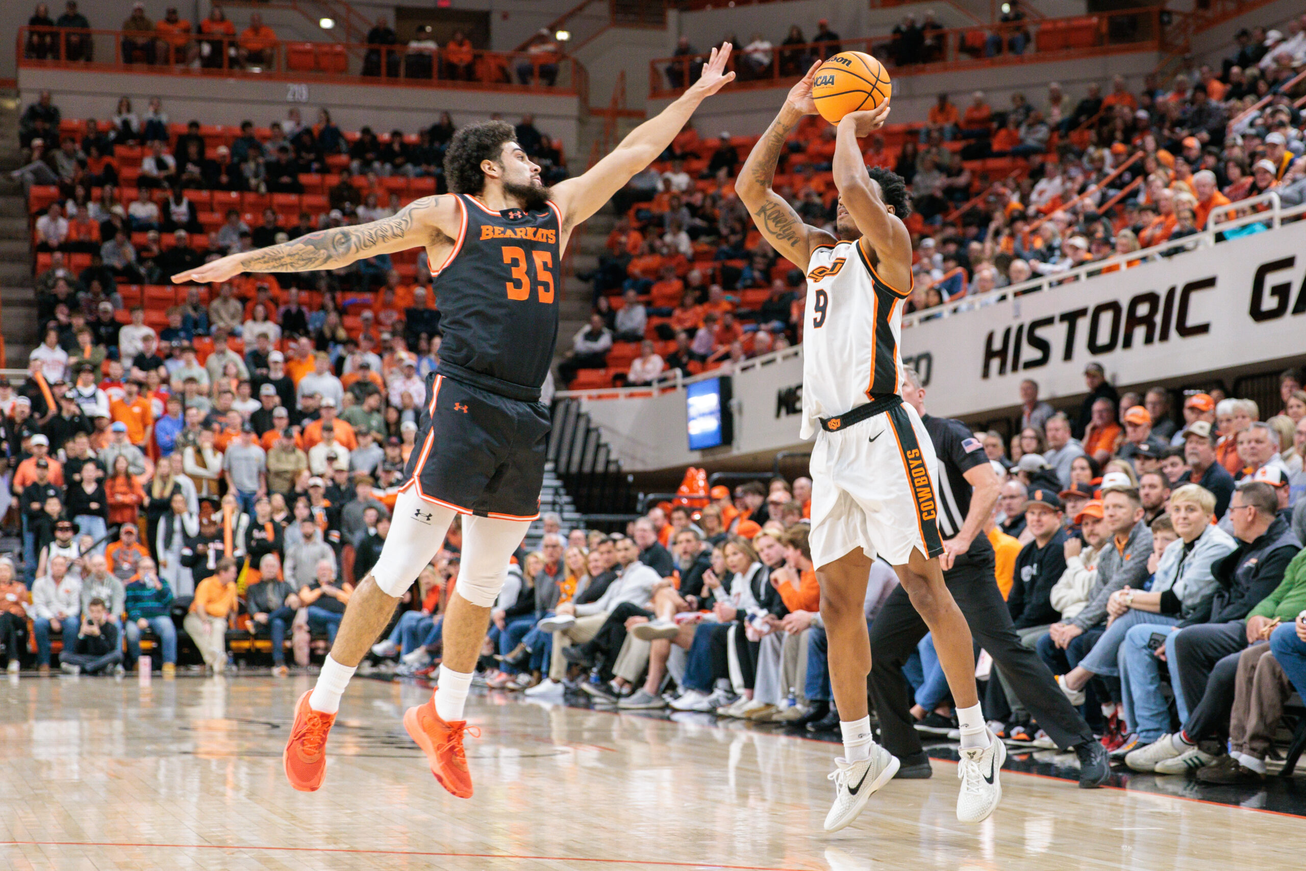 Dec 2, 2025; Stillwater, Oklahoma, USA; Oklahoma State Cowboys guard Anthony Roy (9) shoots the ball over Sam Houston Bearkats guard Po'Boigh King (35) during the second half at Gallagher-Iba Arena. Mandatory Credit: William Purnell-Imagn Images