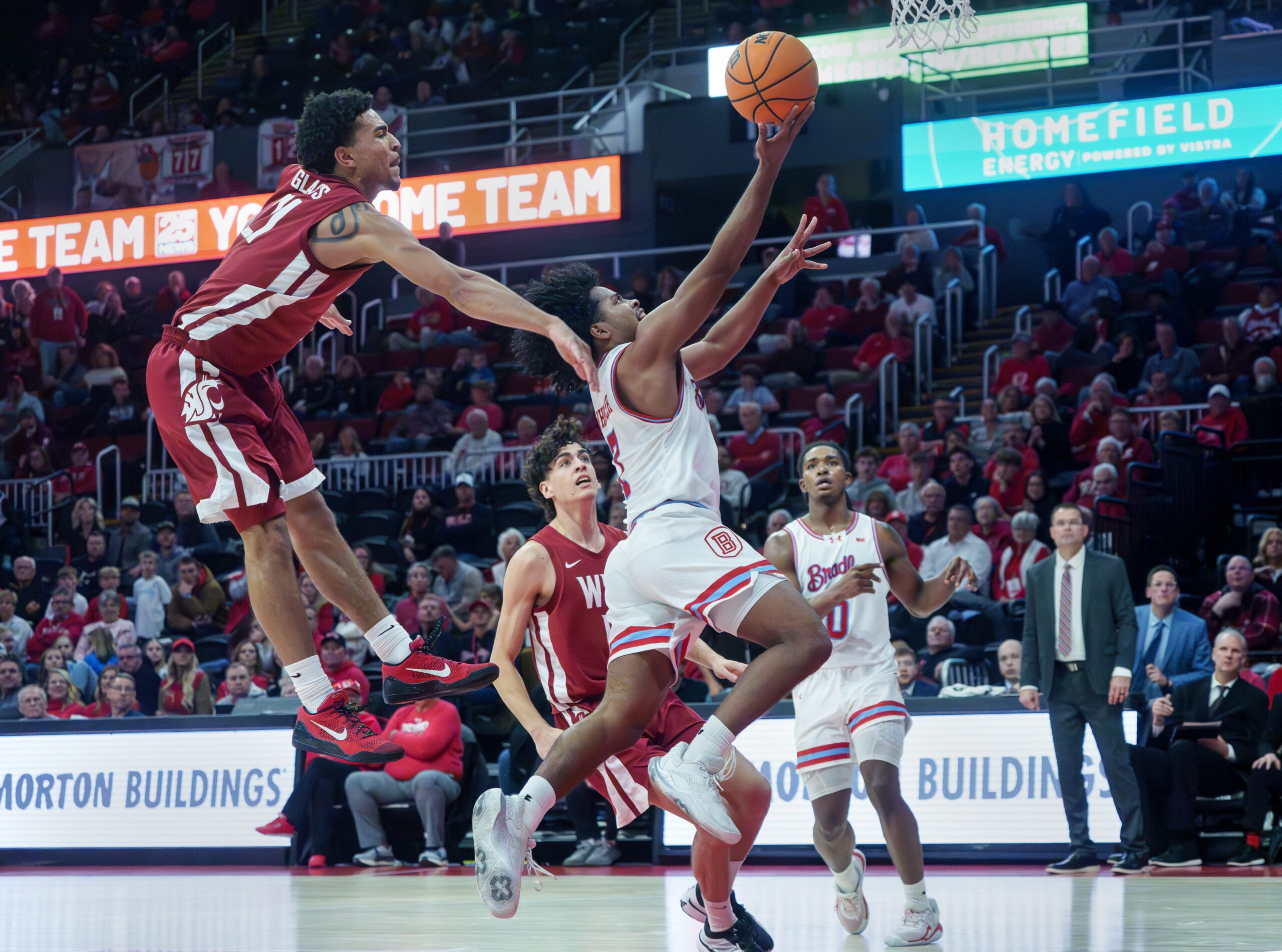 Bradley’s Montana Wheeler gets past Washington State’s Ace Glass for a shot in the second half of their college basketball game Tuesday, Dec. 2, 2025 at Carver Arena in Peoria. The Braves rallied for a 64-60 victory.