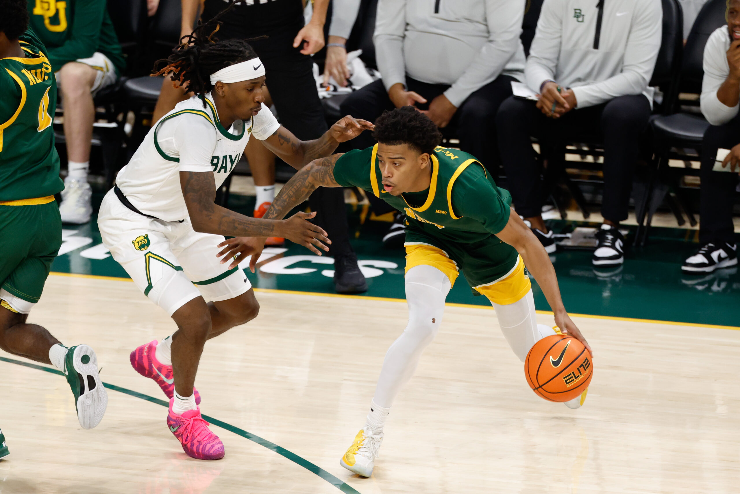 Dec 10, 2025; Waco, Texas, USA;  Norfolk State Spartans guard Anthony McComb III (7) controls the ball as Baylor Bears guard Obi Agbim (5) defends during the first half at Paul and Alejandra Foster Pavilion. Mandatory Credit: Chris Jones-Imagn Images