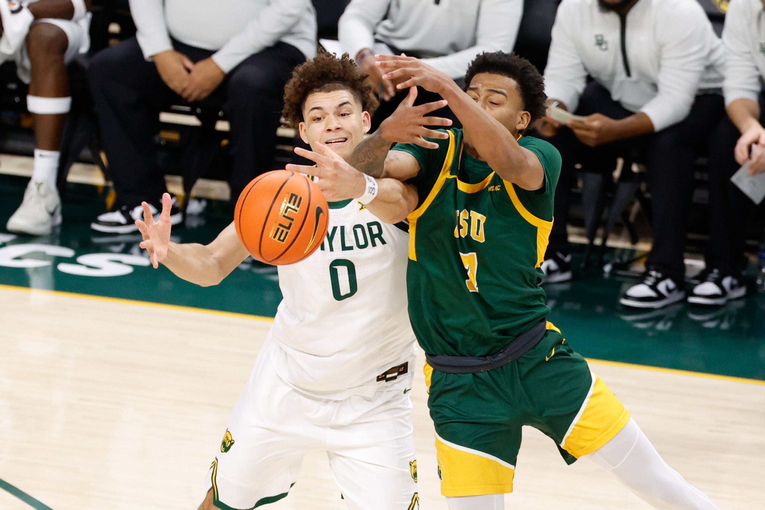 Dec 10, 2025; Waco, Texas, USA;  Norfolk State Spartans guard Anthony McComb III (7) and Baylor Bears guard Dan Skillings Jr. (0) chase a loose ball during the first half at Paul and Alejandra Foster Pavilion. Mandatory Credit: Chris Jones-Imagn Images