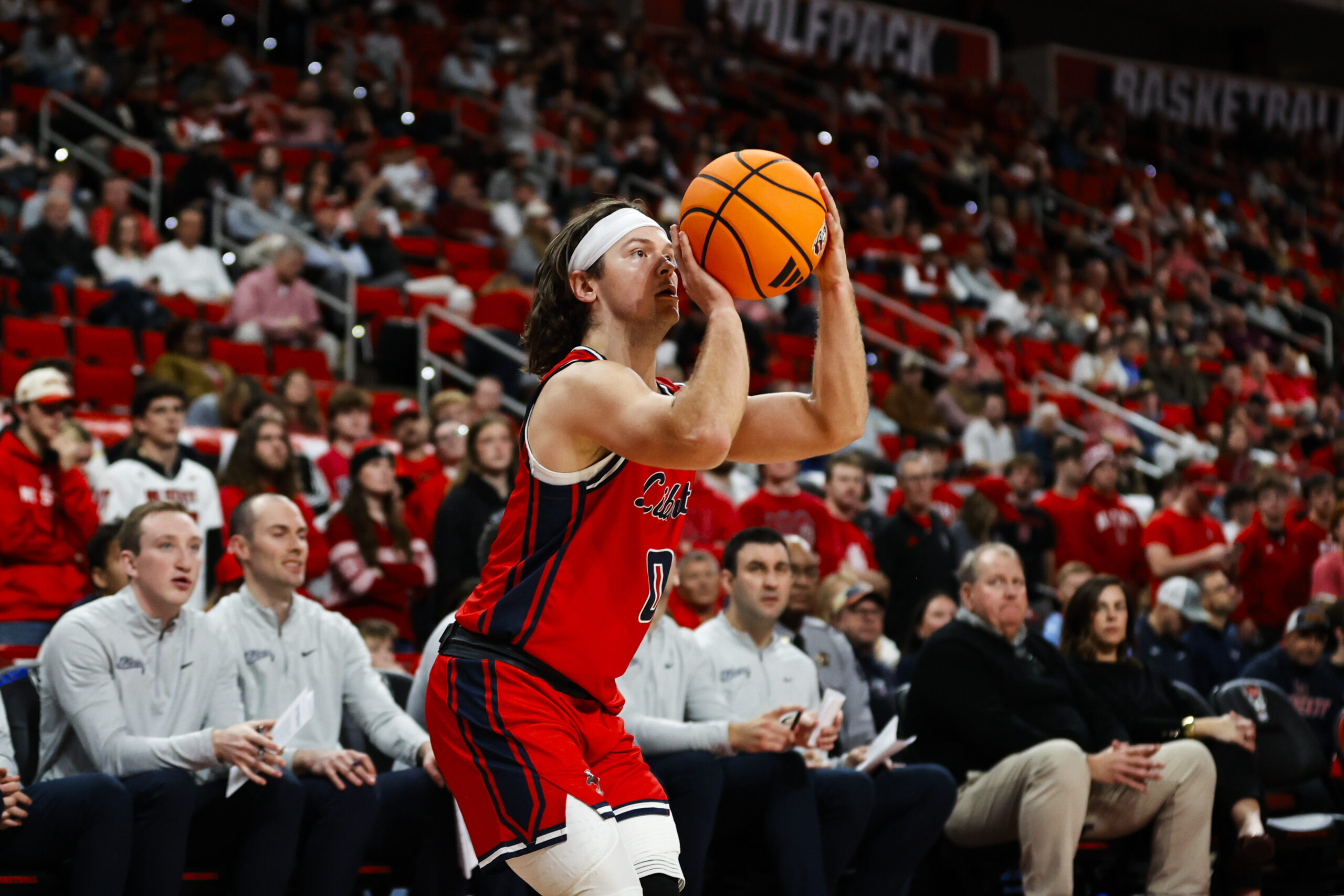 Dec 6, 2025; Raleigh, North Carolina, USA; Liberty Flames guard Colin Porter (0) shoots a three point shot during the second half of the game against the NC State Wolfpack at Lenovo Center. Mandatory Credit: Jaylynn Nash-Imagn Images