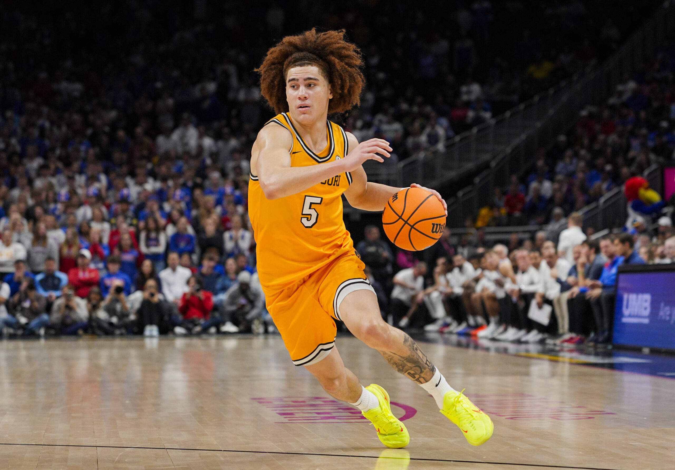Dec 7, 2025; Kansas City, Missouri, USA; Missouri Tigers guard T.O. Barrett (5) dribbles the ball during the second half against the Kansas Jayhawks at T-Mobile Center. Mandatory Credit: Jay Biggerstaff-Imagn Images
