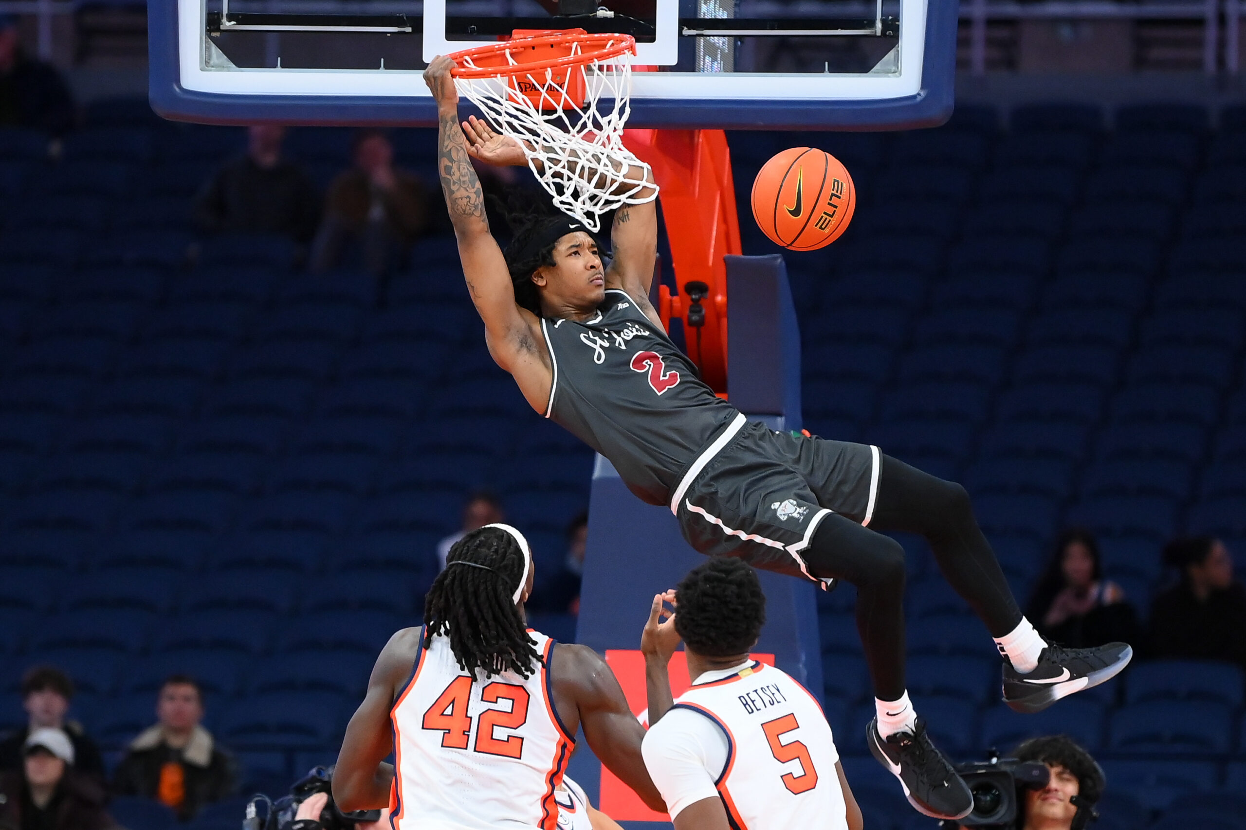 Dec 11, 2025; Syracuse, New York, USA; Saint Joseph's Hawks guard Deuce Jones (2) attempts a dunk as Syracuse Orange forward William Kyle III (42) and forward Tyler Betsey (5) defend during the second half at the JMA Wireless Dome. Mandatory Credit: Rich Barnes-Imagn Images