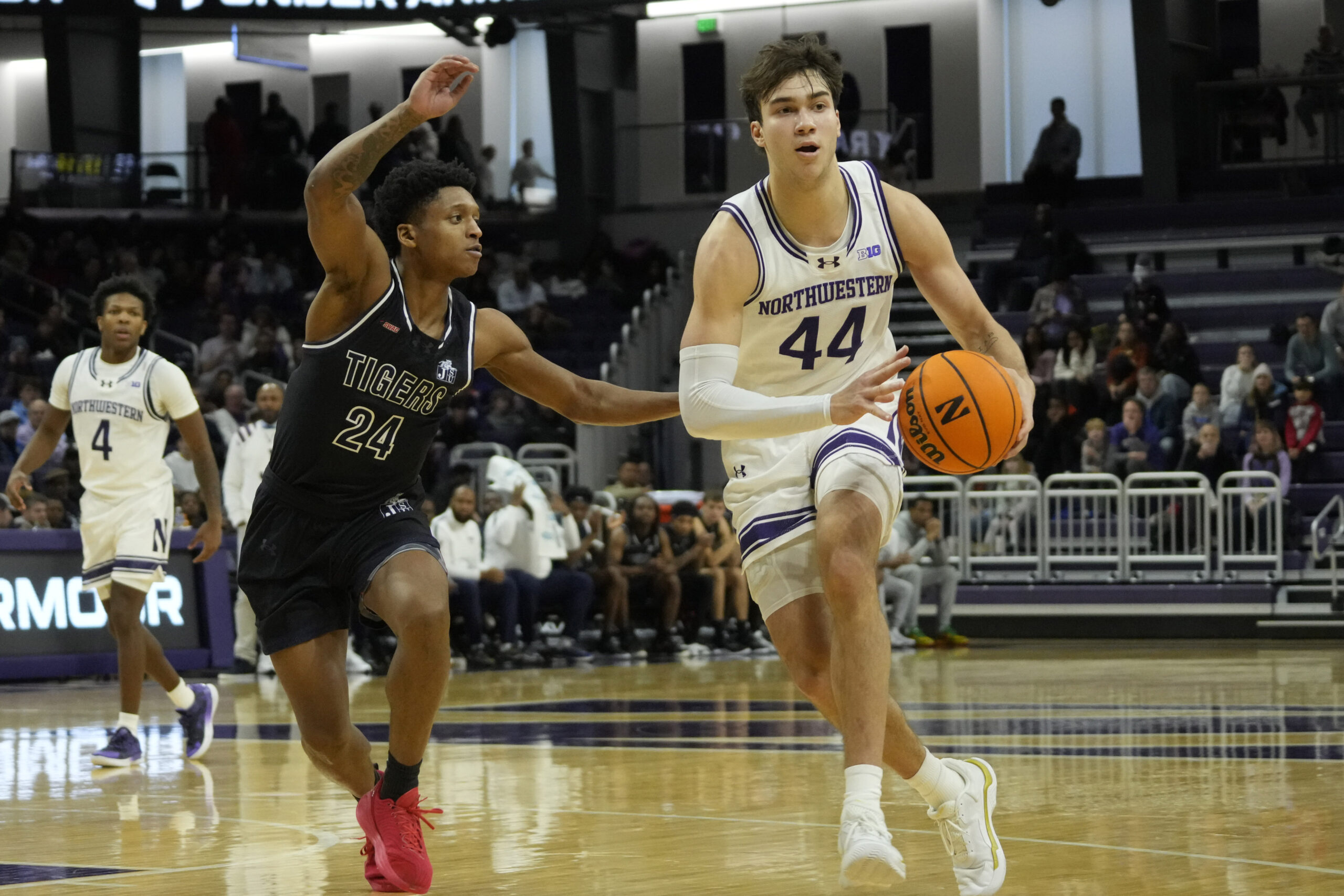 Dec 13, 2025; Evanston, Illinois, USA; Jackson State Tigers guard Daeshun Ruffin (24) defends Northwestern Wildcats guard Angelo Ciaravino (44) during the second half at Welsh-Ryan Arena. Mandatory Credit: David Banks-Imagn Images