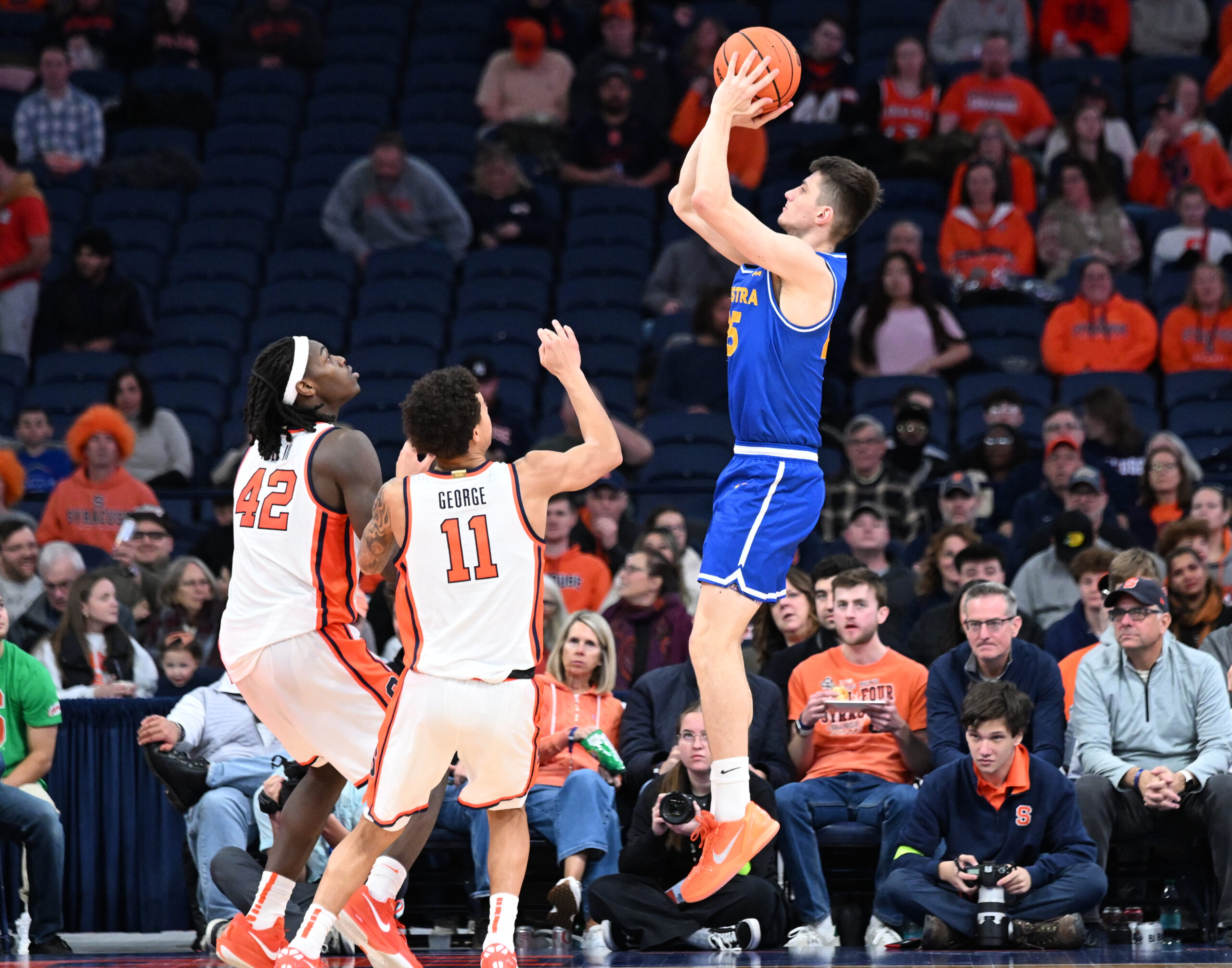 Dec 13, 2025; Syracuse, New York, USA; Hofstra Pride guard German Plotnikov (25) shoots against Syracuse Orange forward William Kyle III (42) and guard Naithan George (11) in the second half at the JMA Wireless Dome. Mandatory Credit: Mark Konezny-Imagn Images