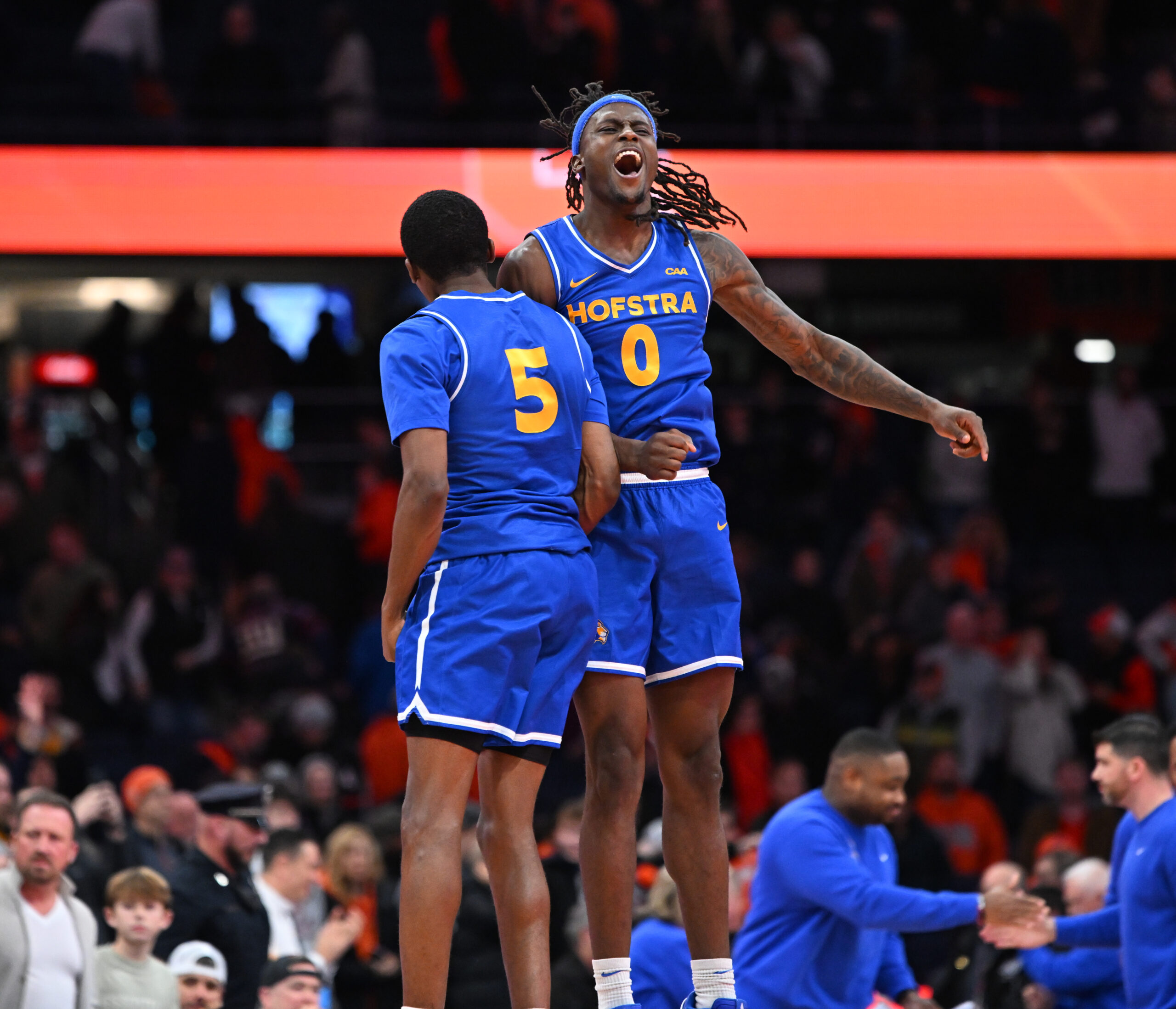 Dec 13, 2025; Syracuse, New York, USA; Hofstra Pride guard Biggie Patterson (0) and guard Cruz Davis (5) react to winning a game against the Syracuse Orange at the JMA Wireless Dome. Mandatory Credit: Mark Konezny-Imagn Images