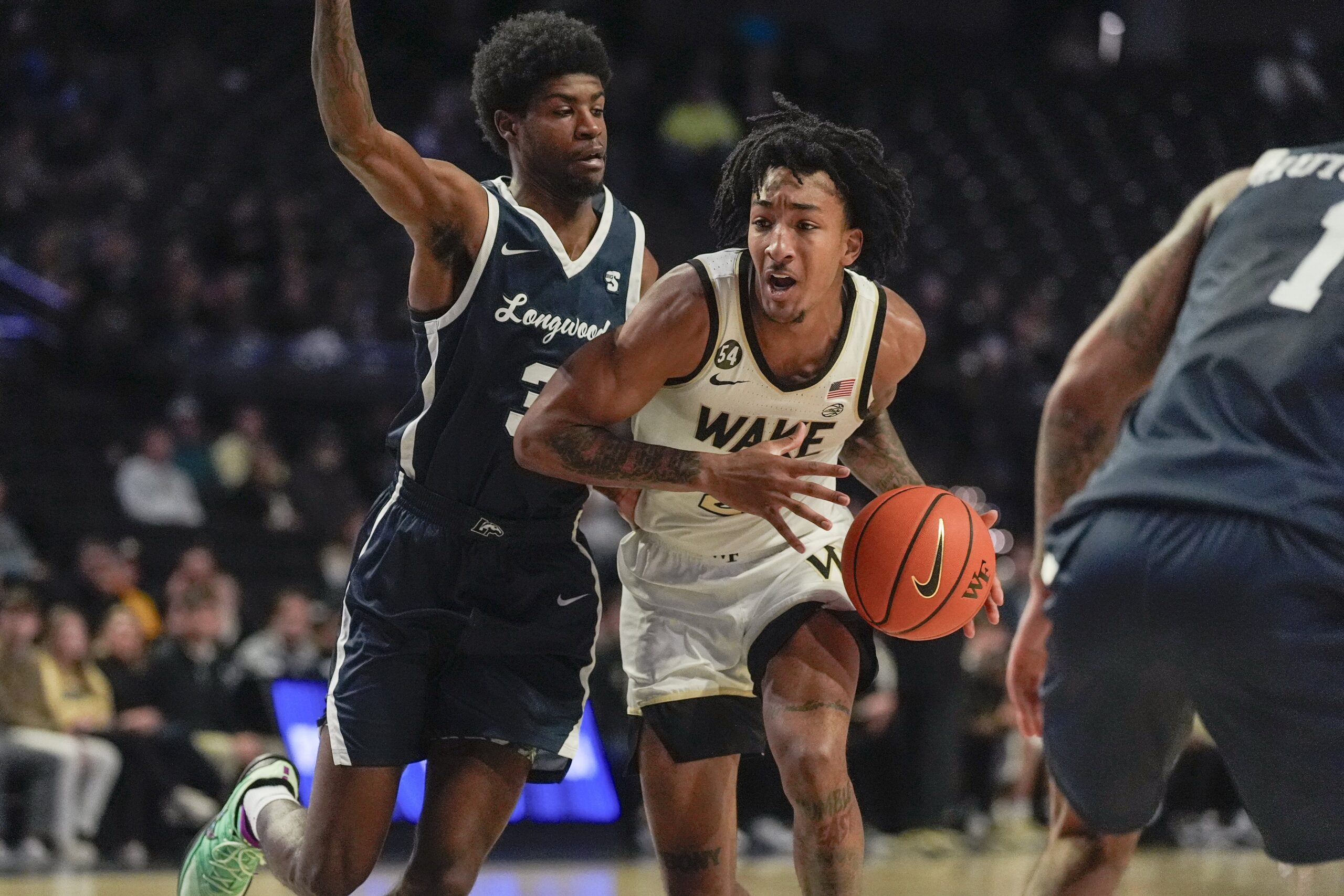 Dec 17, 2025; Winston-Salem, North Carolina, USA;  Wake Forest Demon Deacons guard Juke Harris (2) handles the ball defended by Longwood Lancers guard Alphonzo Billups III (3) during the first half at Lawrence Joel Veterans Memorial Coliseum. Mandatory Credit: Jim Dedmon-Imagn Images