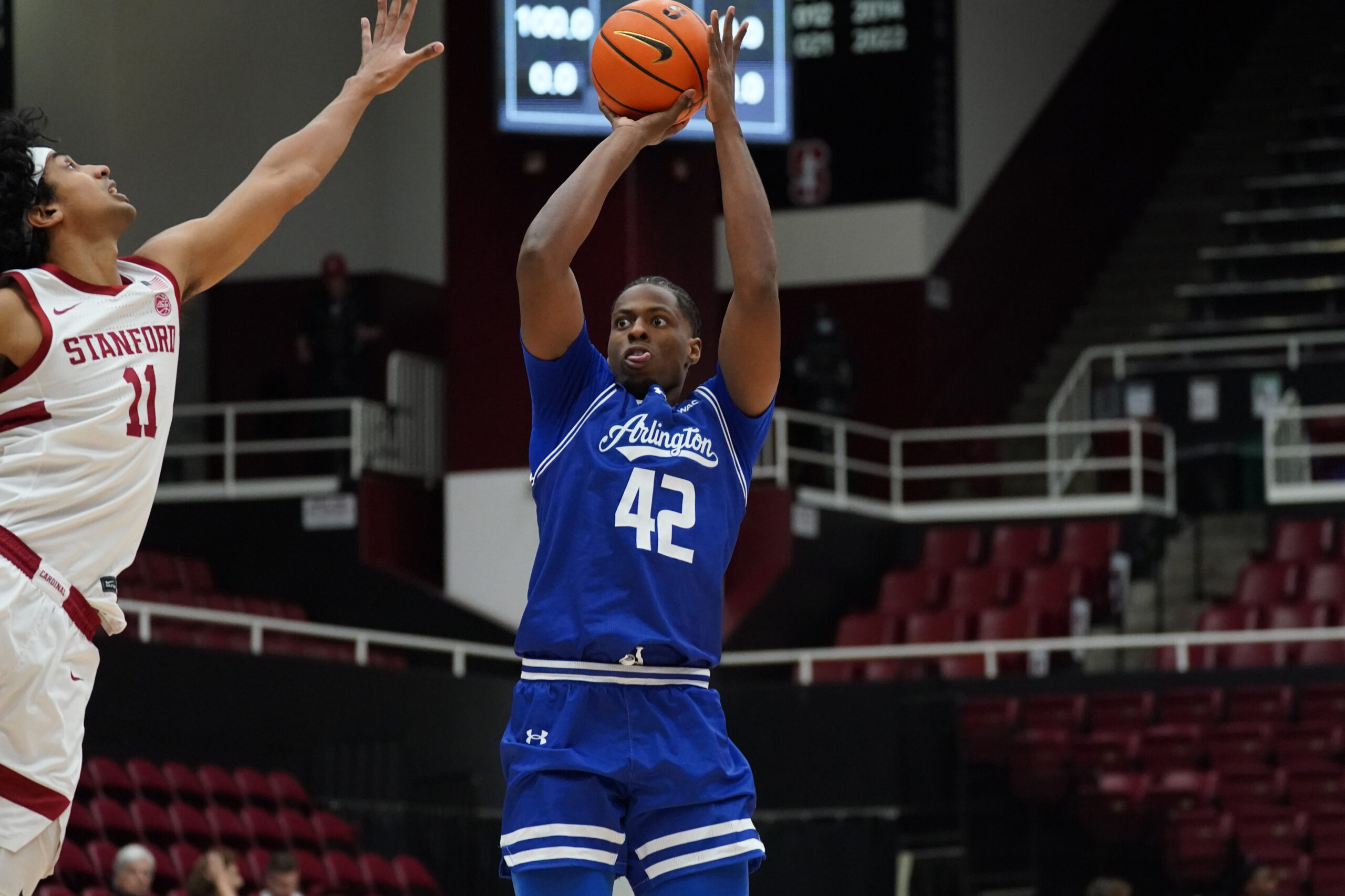 Dec 17, 2025; Stanford, California, USA; Texas-Arlington Mavericks guard Marcell McCreary (42) shoots over Stanford Cardinal guard Ryan Agarwal (11) in the first half at Maples Pavilion. Mandatory Credit: David Gonzales-Imagn Images