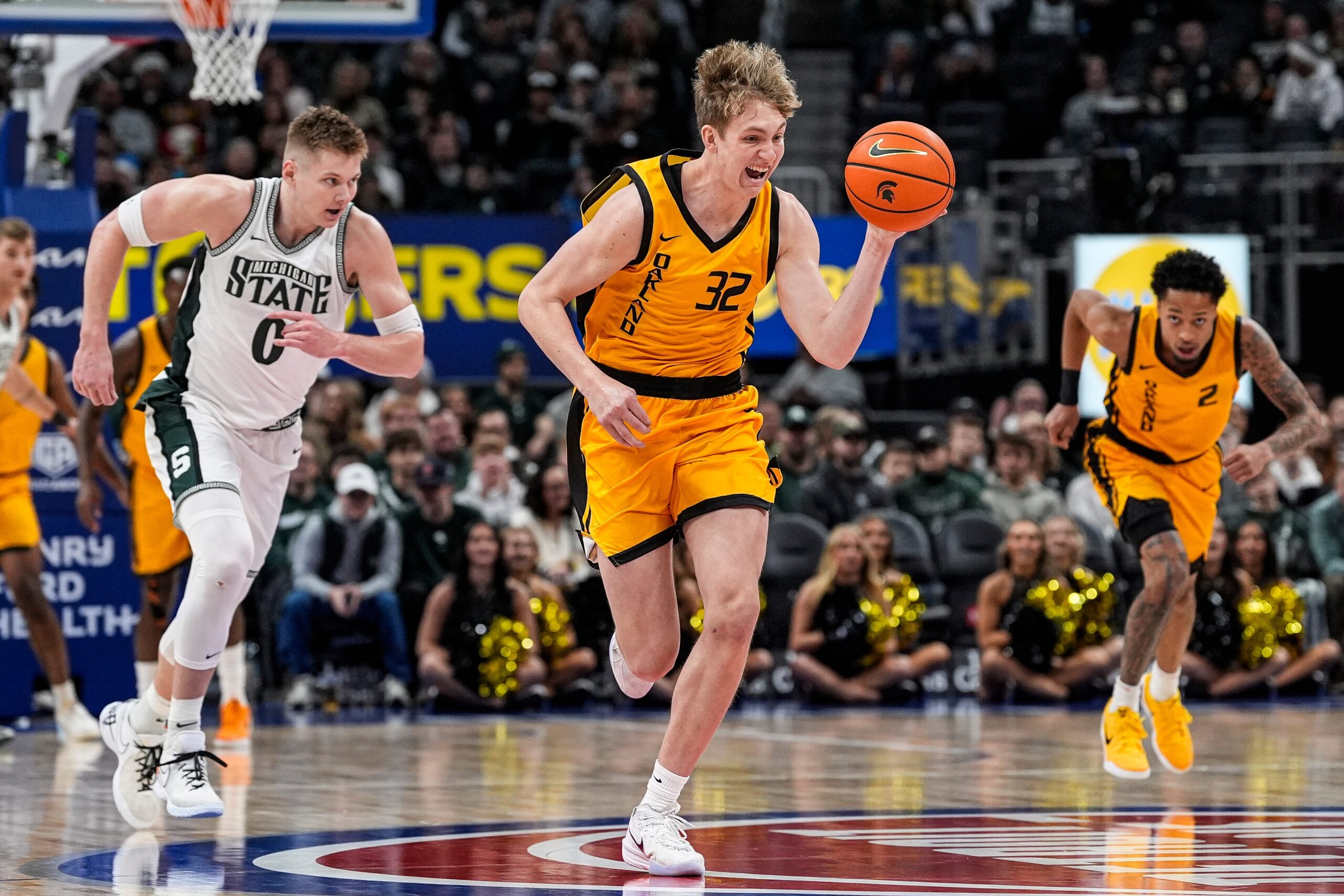 Oakland forward Isaac Garrett (32) dribbles against Michigan State during the first half at Little Caesars Arena in Detroit on Saturday, Dec. 20, 2025.
