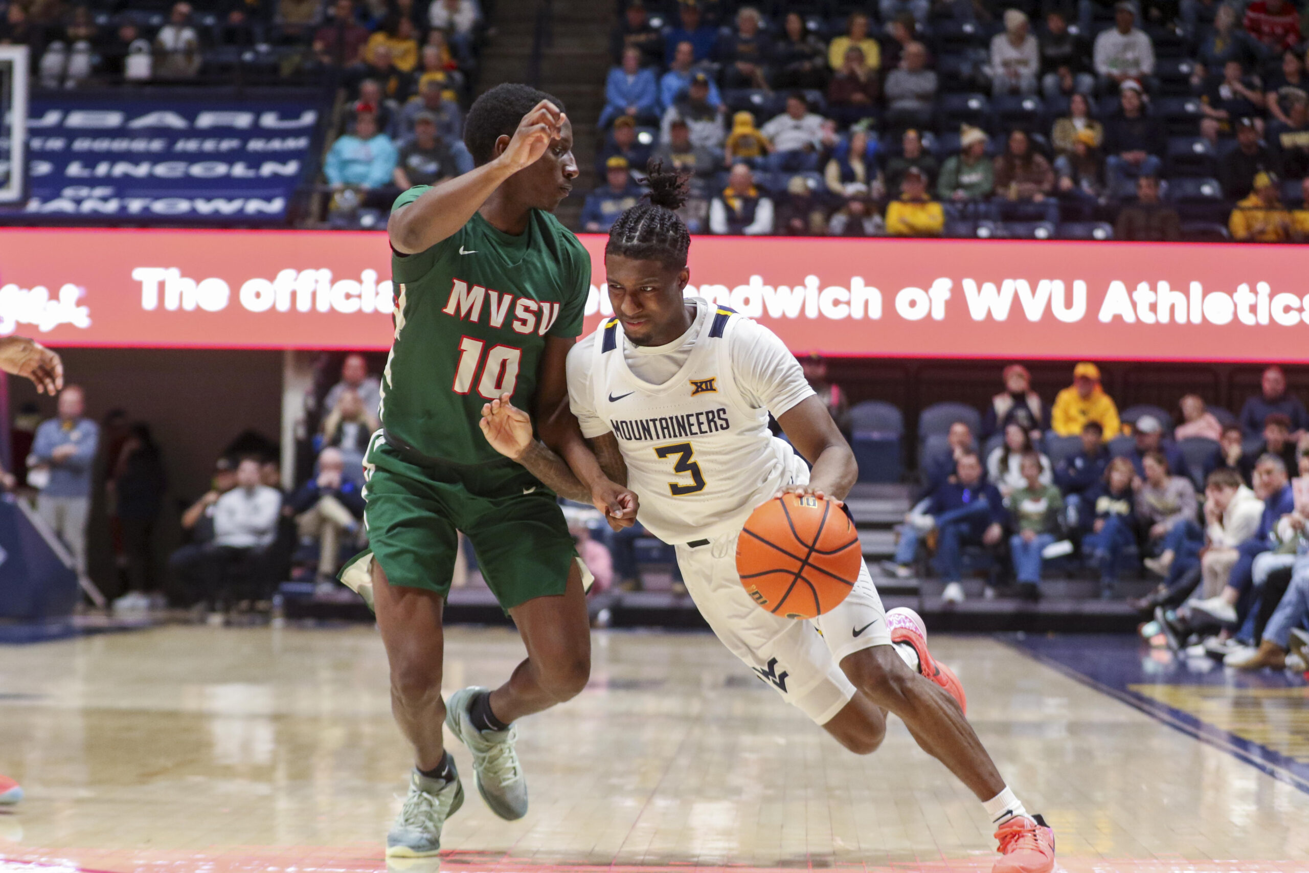 Dec 22, 2025; Morgantown, West Virginia, USA; West Virginia Mountaineers guard Honor Huff (3) drives against Mississippi Valley State Delta Devils guard Michael James (10) during the second half at Hope Coliseum. Mandatory Credit: Ben Queen-Imagn Images