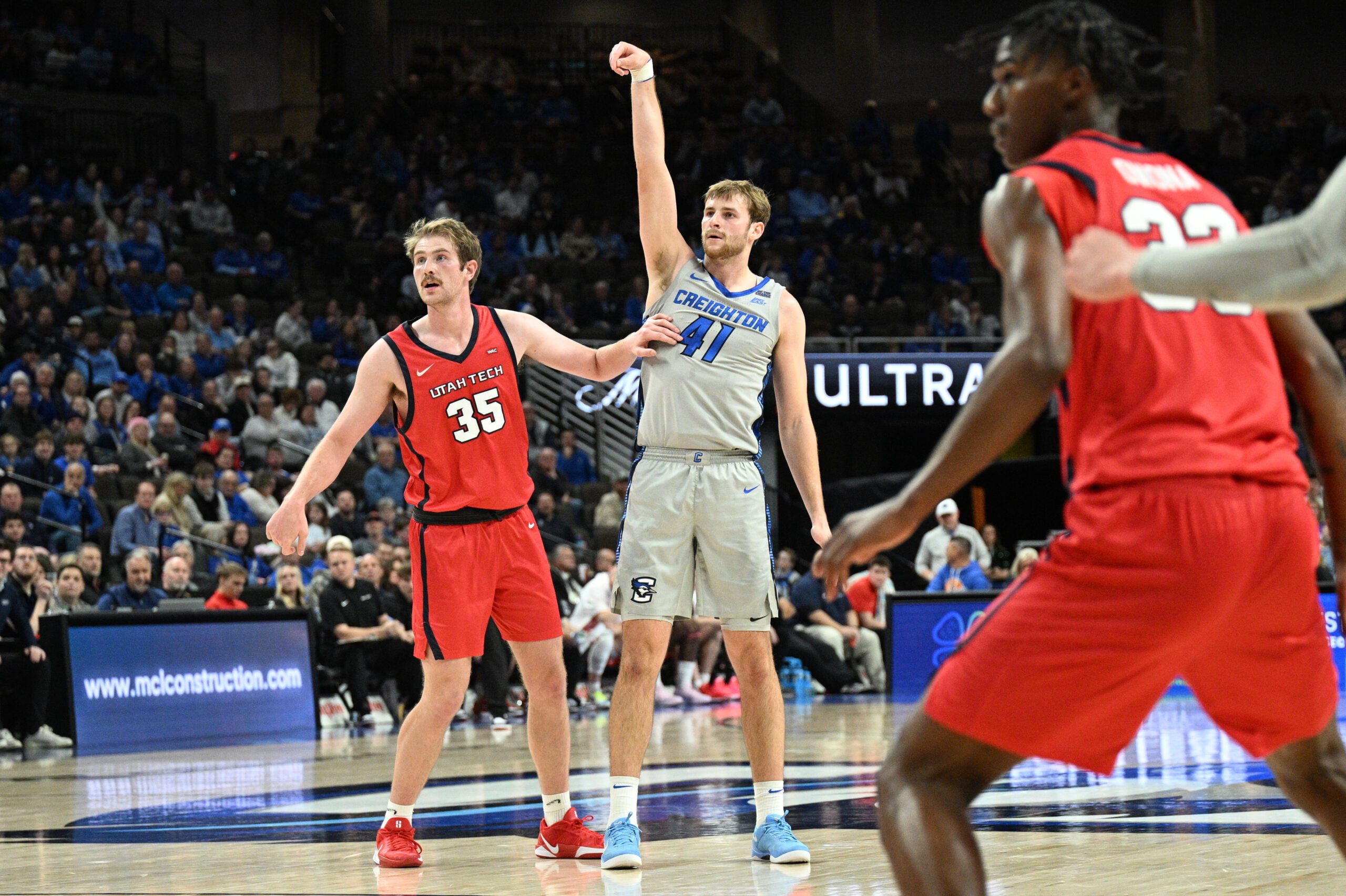Dec 22, 2025; Omaha, Nebraska, USA; Creighton Bluejays forward Isaac Traudt (41) watches a three point basket fall against Utah Tech Trailblazers forward Ethan Potter (35) during the second half at CHI Health Center Omaha. Mandatory Credit: Steven Branscombe-Imagn Images