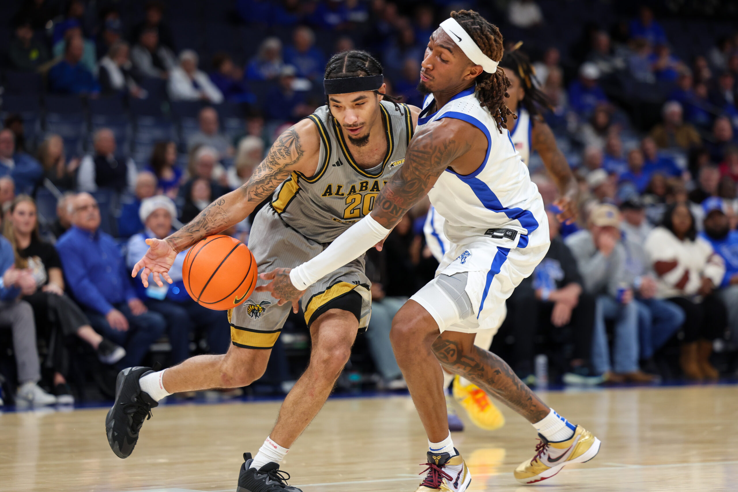 Dec 22, 2025; Memphis, Tennessee, USA; Alabama State Hornets guard Asjon Anderson (20) handles the ball against  Memphis Tigers guard Zach Davis (2) during the second half at FedExForum. Mandatory Credit: Wesley Hale-Imagn Images