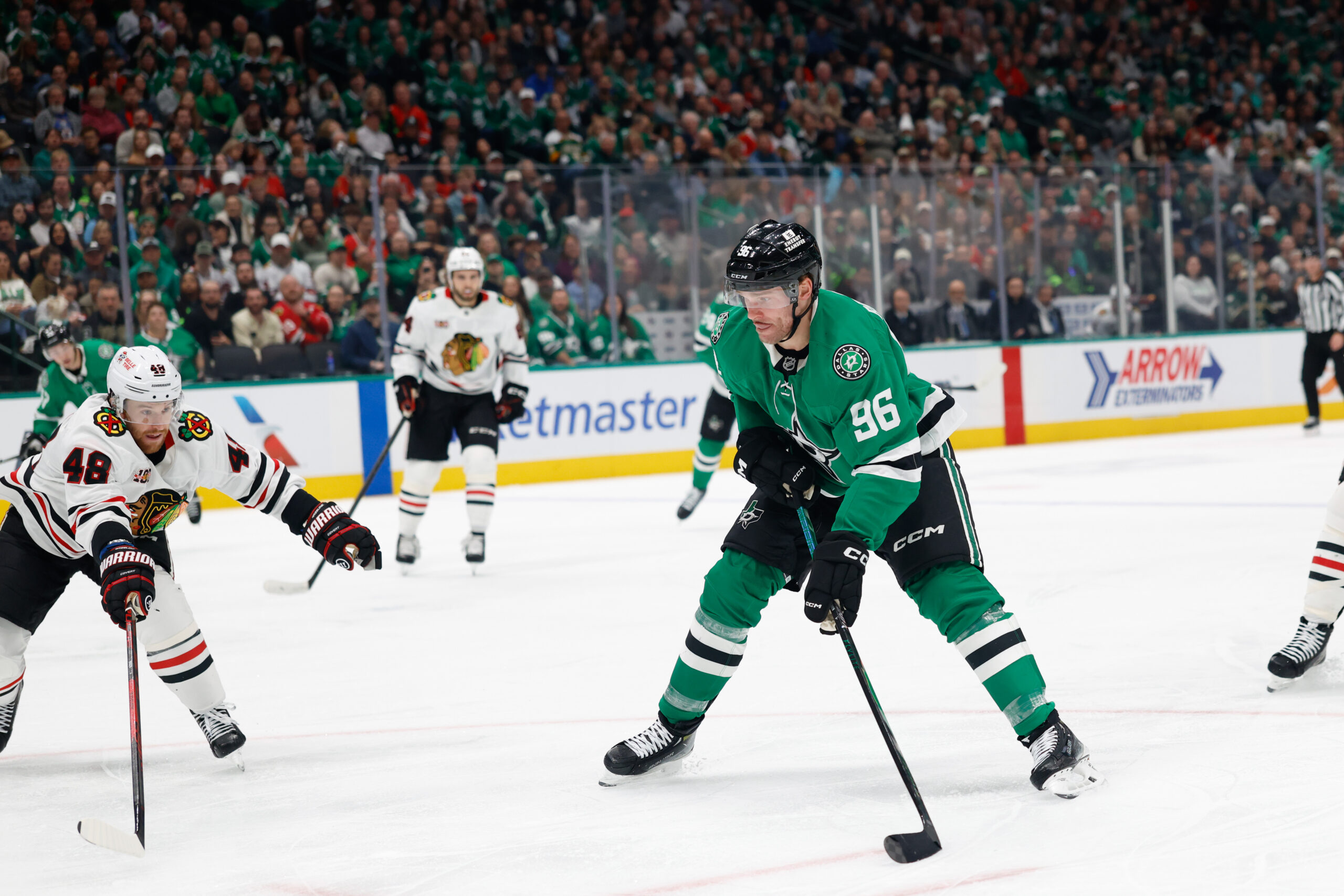 Dec 27, 2025; Dallas, Texas, USA;  Dallas Stars right wing Mikko Rantanen (96) shoots the puck against Chicago Blackhawks defenseman Matt Grzelcyk (48) during the second period at American Airlines Center. Mandatory Credit: Chris Jones-Imagn Images