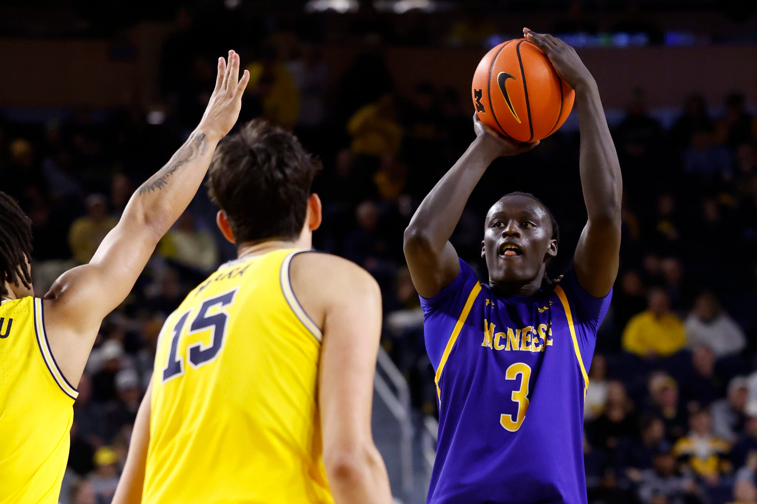Dec 29, 2025; Ann Arbor, Michigan, USA;  McNeese Cowboys guard Garwey Dual (3) shoots in the second half against the Michigan Wolverines at Crisler Center. Mandatory Credit: Rick Osentoski-Imagn Images