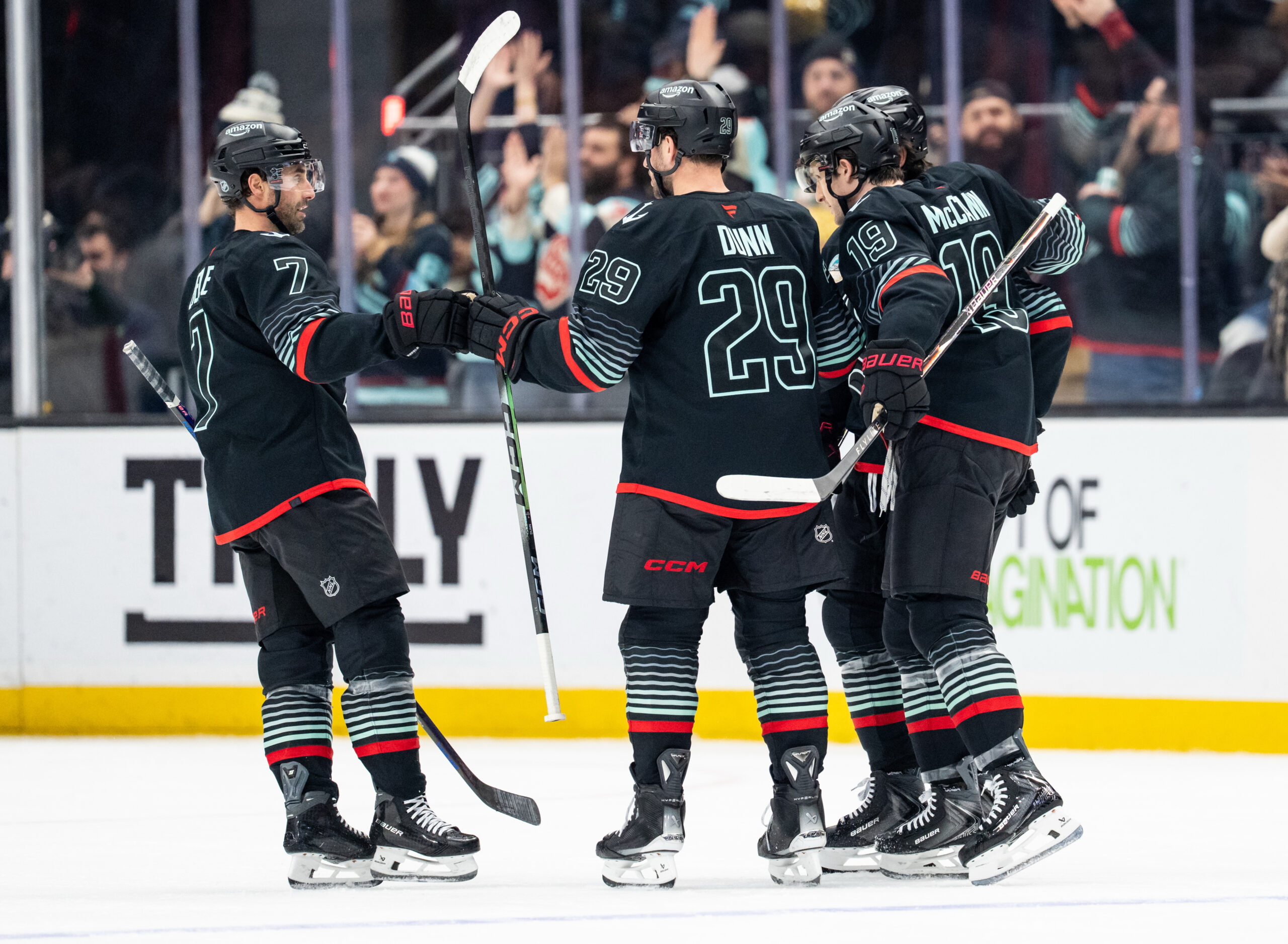 Dec 29, 2025; Seattle, Washington, USA; Seattle Kraken including forward Jordan Eberle (7), defenseman Vince Dunn (29) and forward Jared McCann (19) celebrate a goal during the first period against the Vancouver Canucks at Climate Pledge Arena. Mandatory Credit: Stephen Brashear-Imagn Images