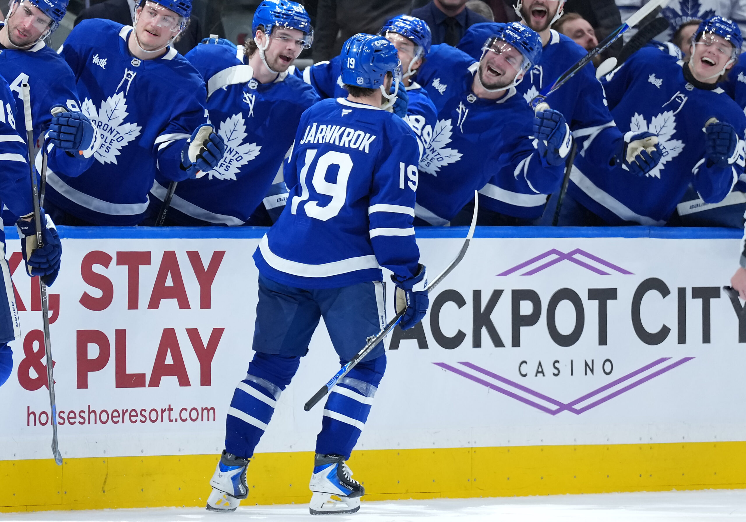 Dec 30, 2025; Toronto, Ontario, CAN; Toronto Maple Leafs center Calle Jarnkrok (19) celebrates at the bench after scoring a goal against the New Jersey Devils during the third period at Scotiabank Arena. Mandatory Credit: Nick Turchiaro-Imagn Images