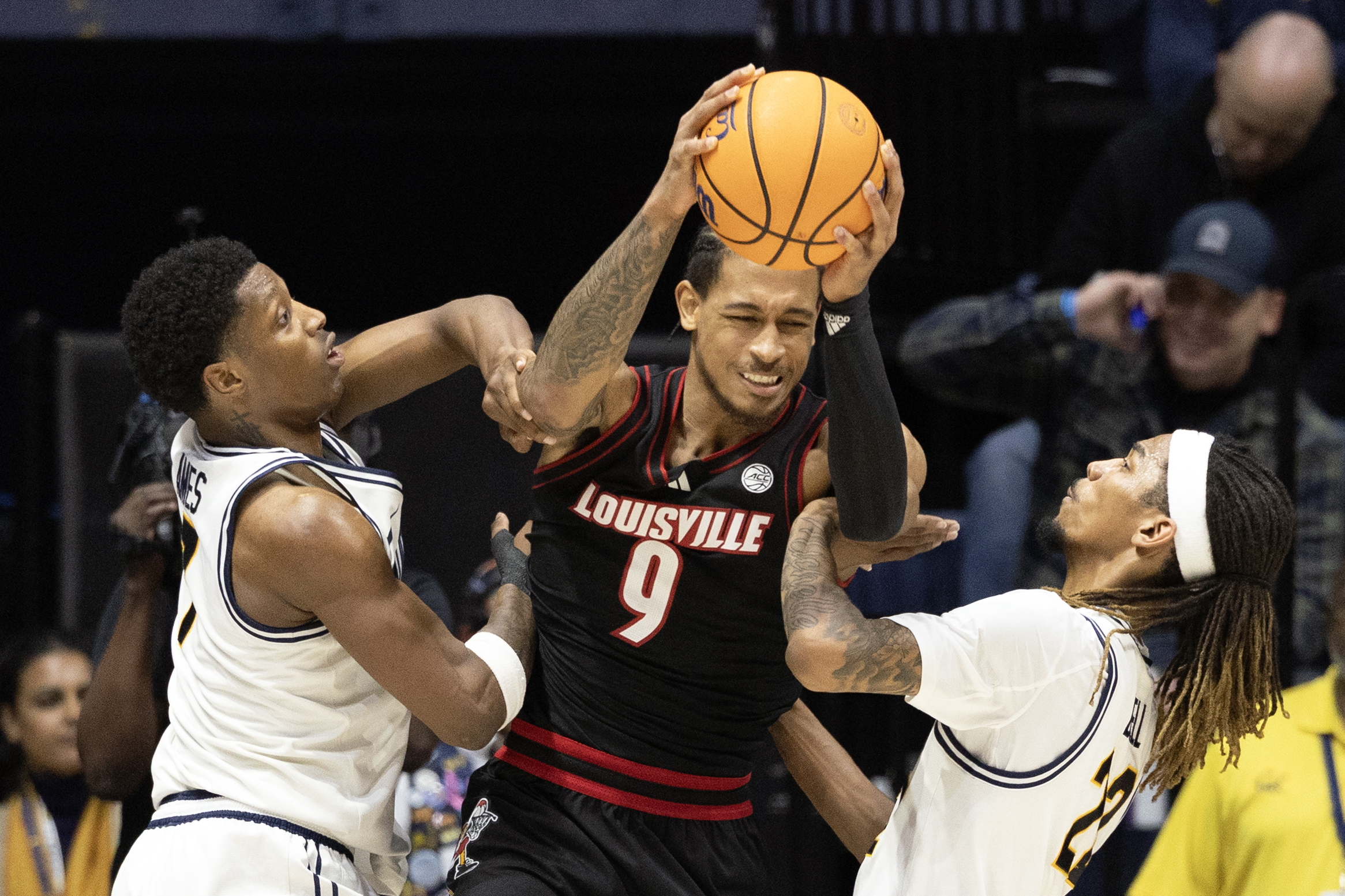 Dec 30, 2025; Berkeley, California, USA; Louisville Cardinals forward Khani Rooths (9) is double-teamed by California Golden Bears defenders Dai Dai Ames (7) and Chris Bell (22) during the second half at Haas Pavilion. Mandatory Credit: D. Ross Cameron-Imagn Images