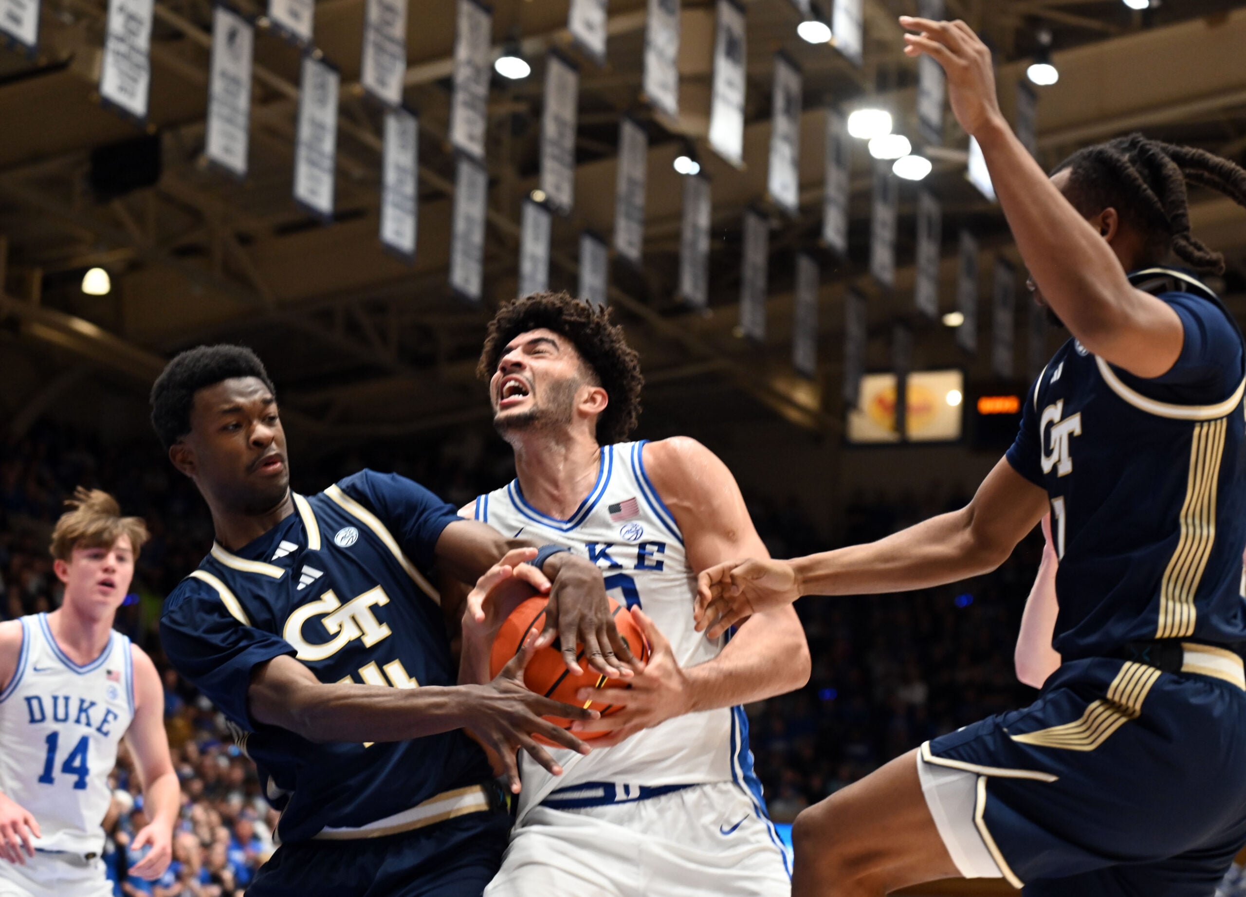 Dec 31, 2025; Durham, North Carolina, USA; Georgia Tech Yellow Jackets forward Kowacie Reeves Jr. (14) attempts to steal the ball from Duke Blue Devils forward Cameron Boozer (12) as he drives to the basket during the second half at Cameron Indoor Stadium.   The Blue Devils won 85-79.  Mandatory Credit: Rob Kinnan-Imagn Images