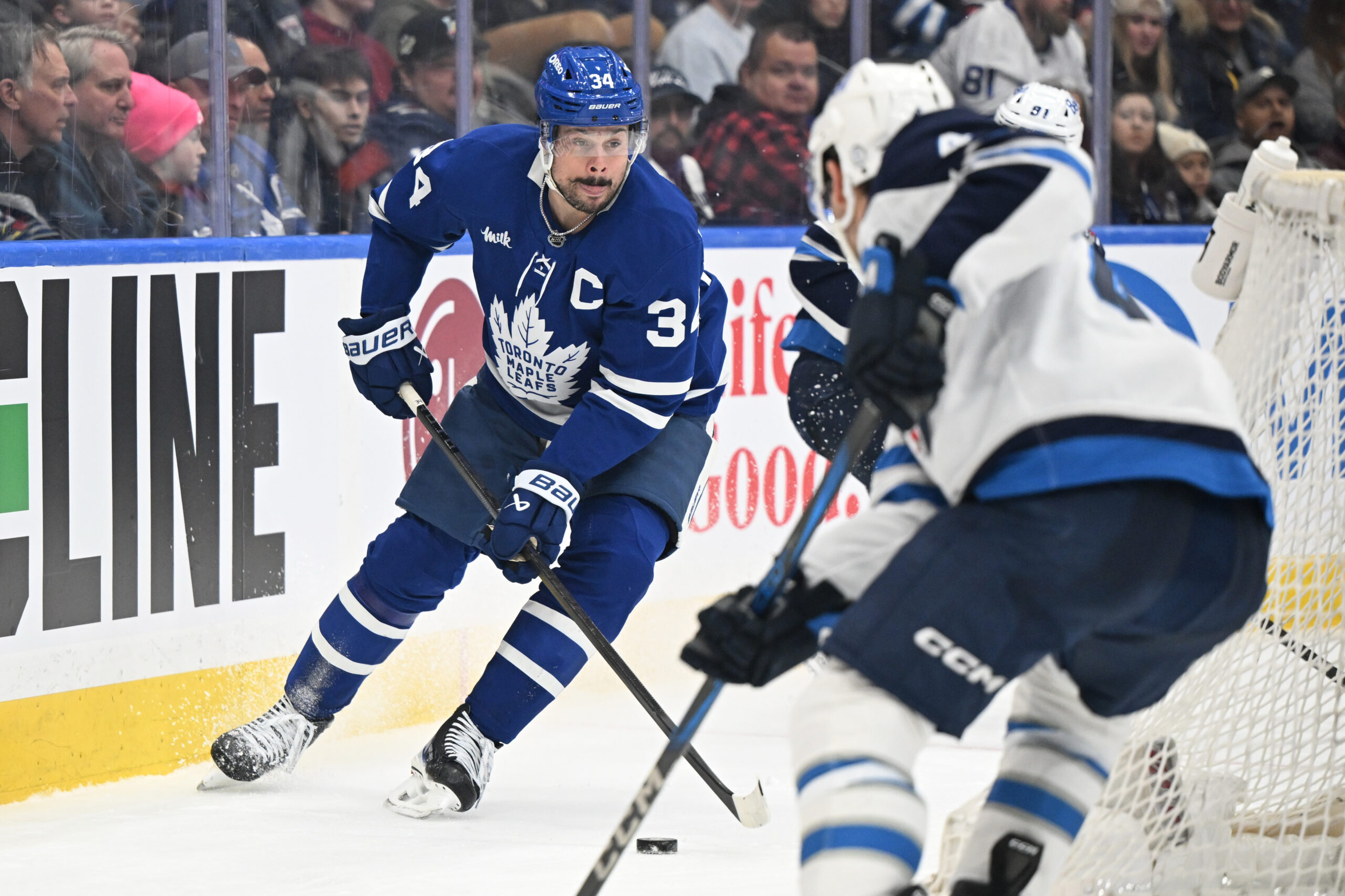 Jan 1, 2026; Toronto, Ontario, CAN;  Toronto Maple Leafs forward Auston Matthews (34) controls the puck behind the Winnipeg Jets goal in the third period at Scotiabank Arena. Mandatory Credit: Dan Hamilton-Imagn Images
