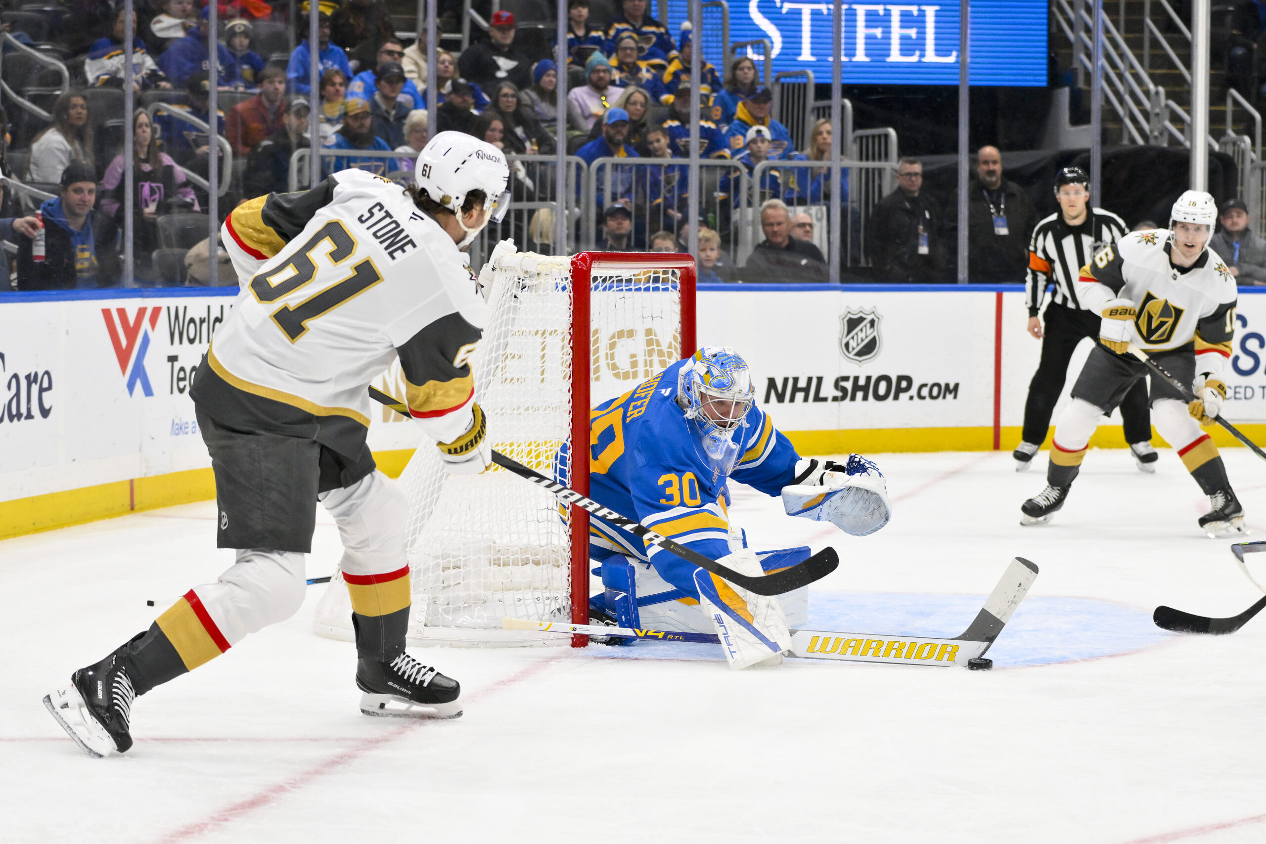 Jan 2, 2026; St. Louis, Missouri, USA; St. Louis Blues goaltender Joel Hofer (30) defends the net against Vegas Golden Knights right wing Mark Stone (61) during the first period at Enterprise Center. Mandatory Credit: Jeff Curry-Imagn Images