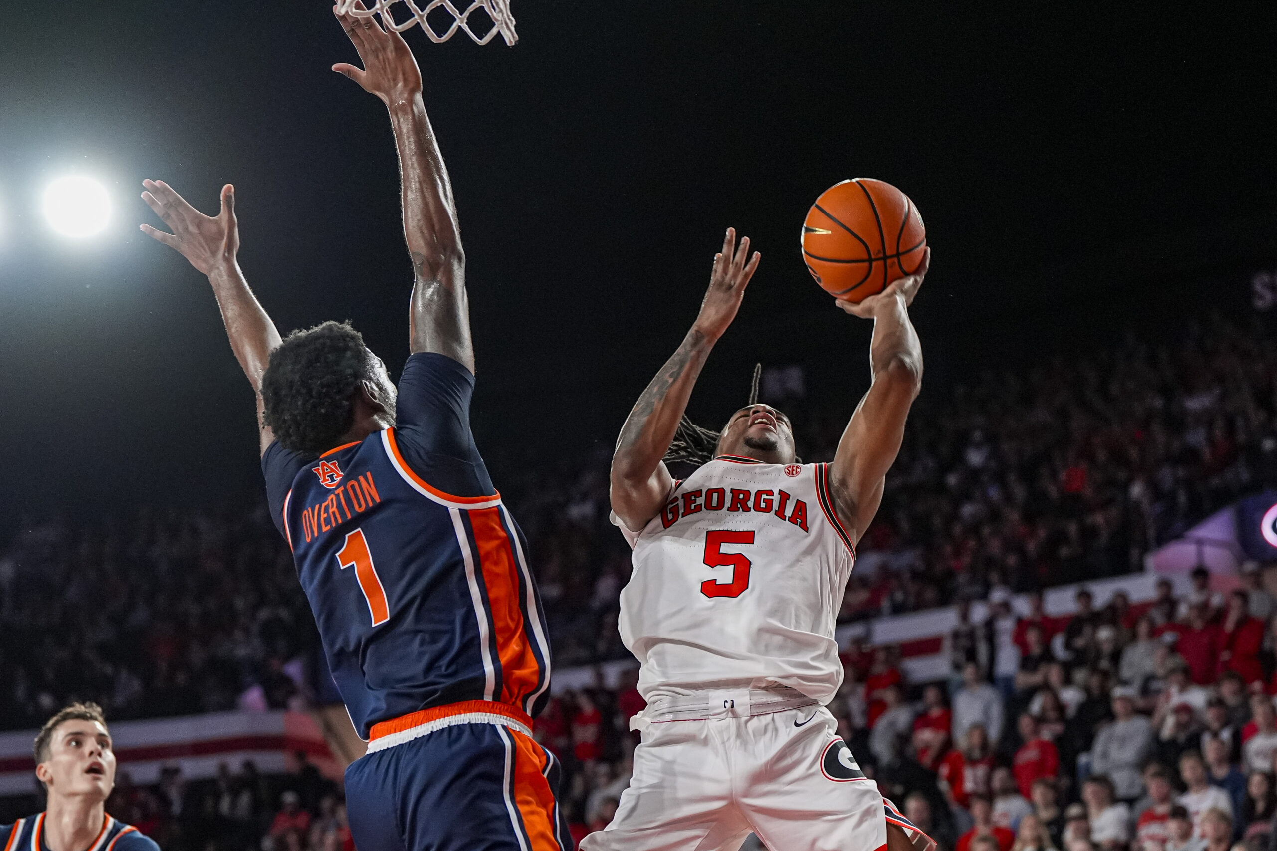 Jan 3, 2026; Athens, Georgia, USA; Georgia Bulldogs guard Jeremiah Wilkinson (5) tries to shoot against Auburn Tigers guard Kevin Overton (1) during the first half at Stegeman Coliseum. Mandatory Credit: Dale Zanine-Imagn Images