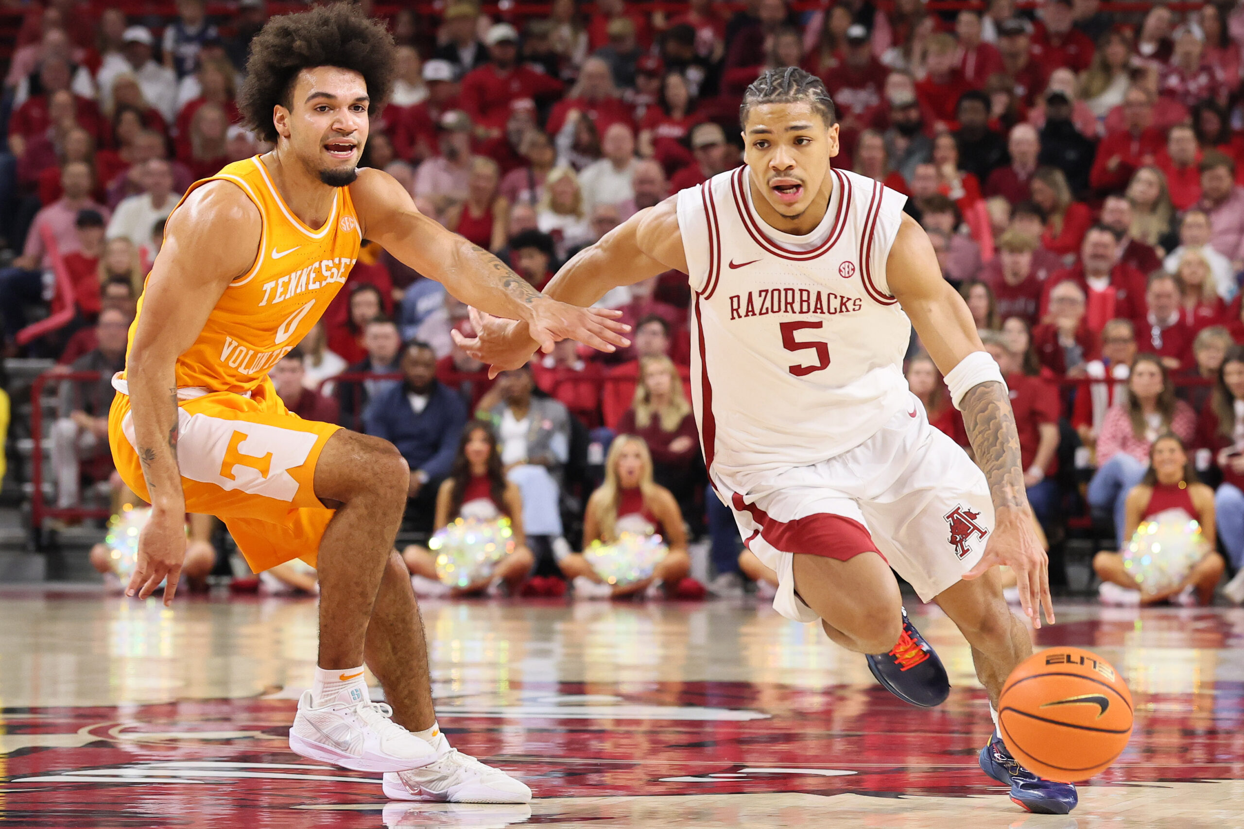 Jan 3, 2026; Fayetteville, Arkansas, USA; Arkansas Razorbacks guard Darius Acuff Jr (5) drives against Tennessee Volunteers guard Jacobi Gillespie (0) during the second half at Bud Walton Arena.  Mandatory Credit: Nelson Chenault-Imagn Images