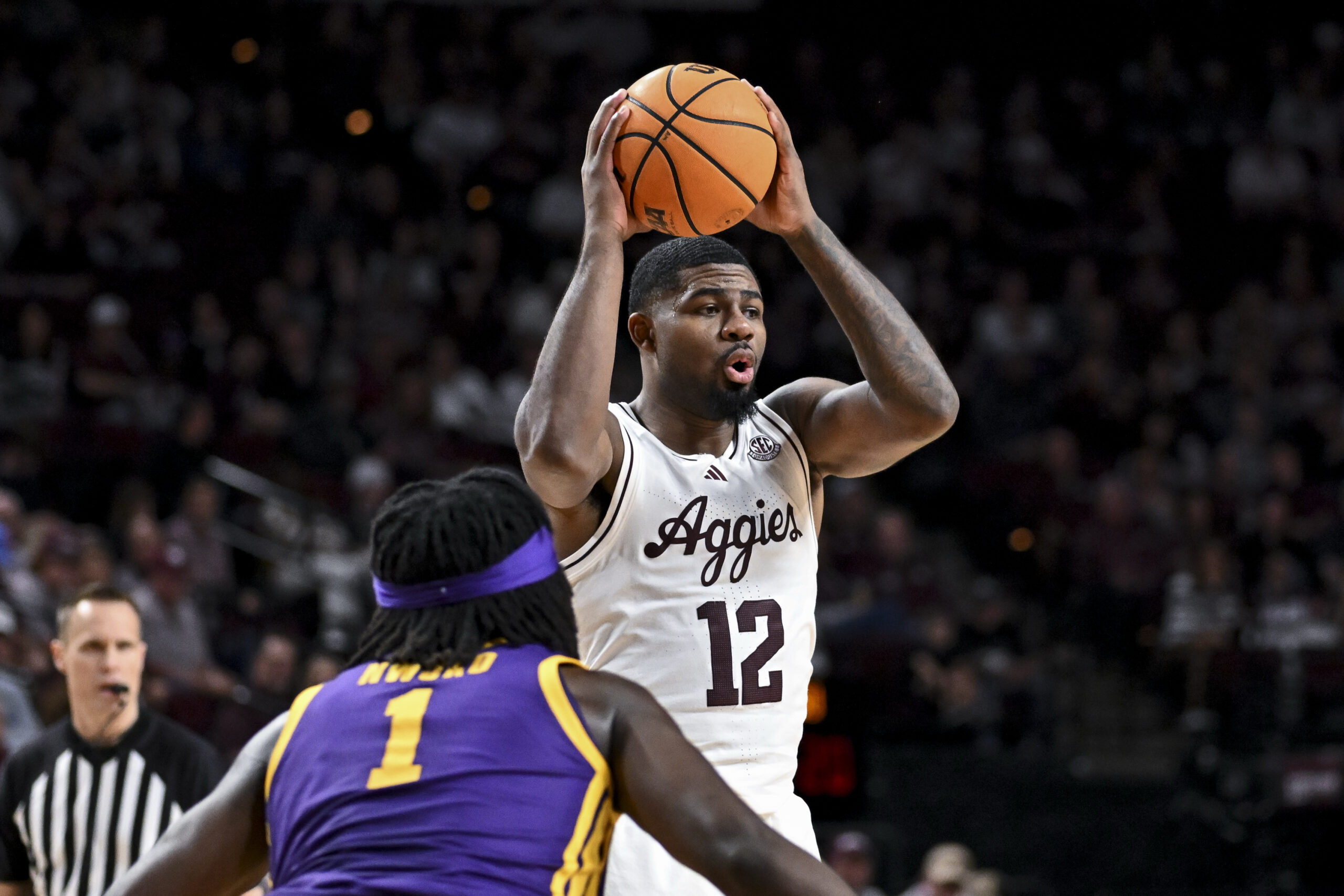 Jan 3, 2026; College Station, Texas, USA;  Texas A&M Aggies forward Rashaun Agee (12) looks to pass the ball against the Louisiana State Tigers at Reed Arena. Mandatory Credit: Maria Lysaker-Imagn Images