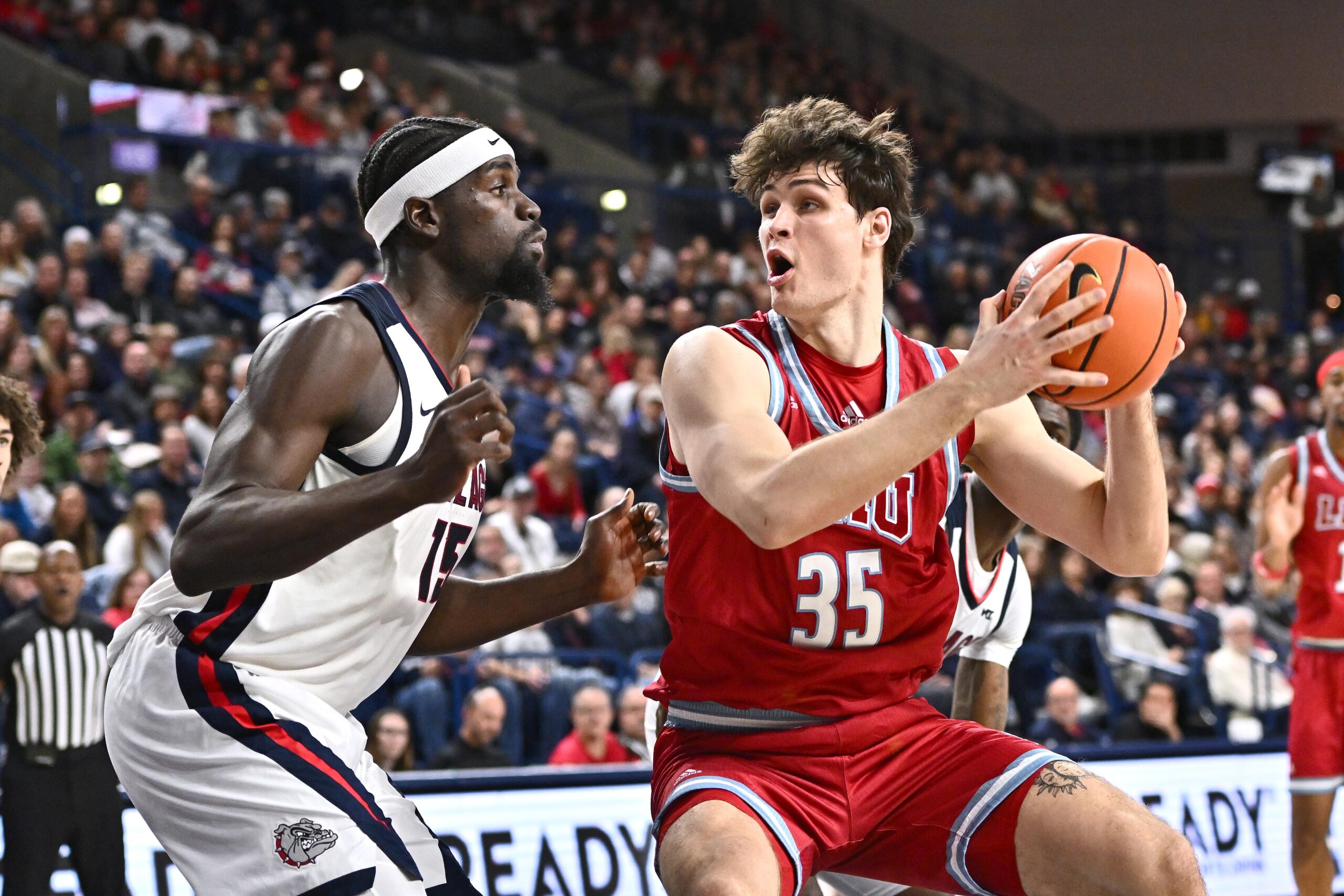 Jan 4, 2026; Spokane, Washington, USA; Loyola Marymount Lions forward Rokas Jocius (35) shoots the ball against Gonzaga Bulldogs forward Graham Ike (15) in the first half at McCarthey Athletic Center. Mandatory Credit: James Snook-Imagn Images