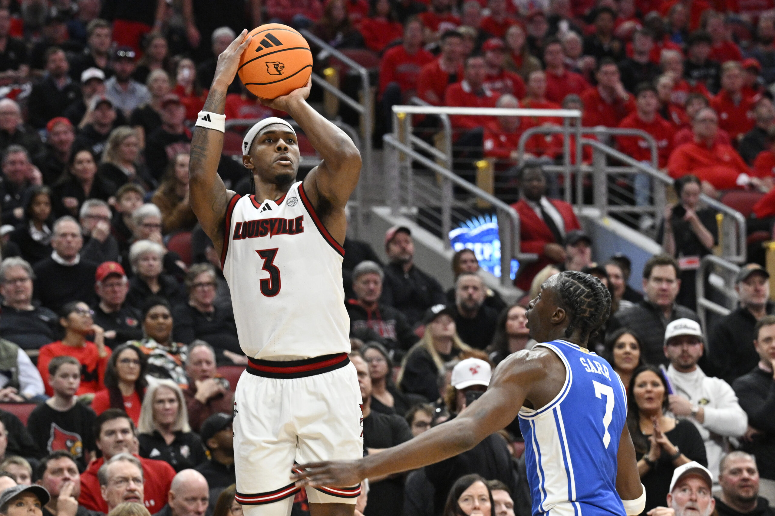 Jan 6, 2026; Louisville, Kentucky, USA;  Louisville Cardinals guard Ryan Conwell (3) shoots against Duke Blue Devils guard Dame Sarr (7) during the second half at KFC Yum! Center. Duke defeated Louisville 84-73. Mandatory Credit: Jamie Rhodes-Imagn Images