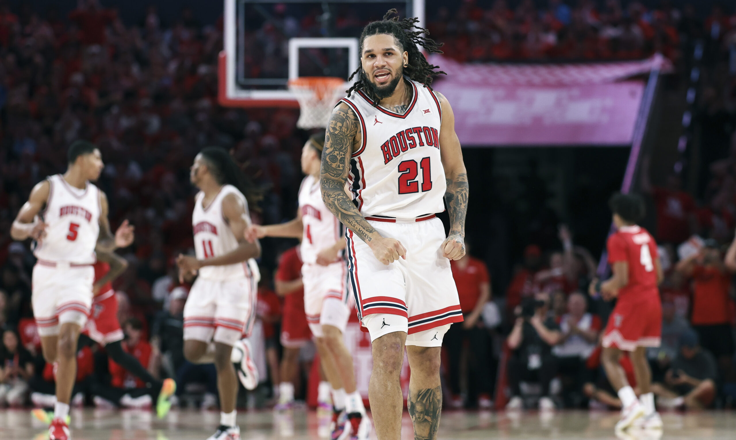 Jan 6, 2026; Houston, Texas, USA; Houston Cougars guard Emanuel Sharp (21) reacts after scoring a basket during the first half against the Texas Tech Red Raiders at Fertitta Center. Mandatory Credit: Troy Taormina-Imagn Images