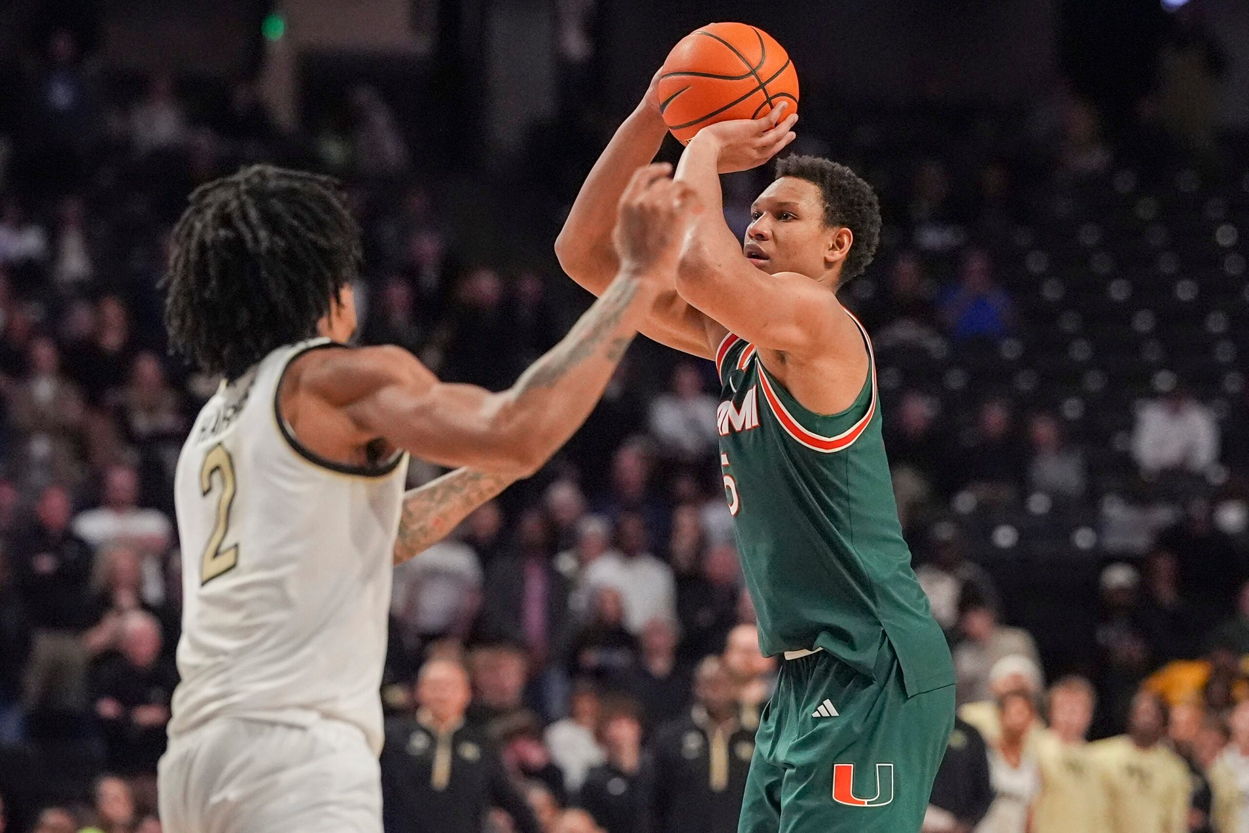 Jan 7, 2026; Winston-Salem, North Carolina, USA; Miami (FL) Hurricanes forward Malik Reneau (5) shoots defended by Wake Forest Demon Deacons forward Juke Harris (2) during the second half at Lawrence Joel Veterans Memorial Coliseum. Mandatory Credit: Jim Dedmon-Imagn Images