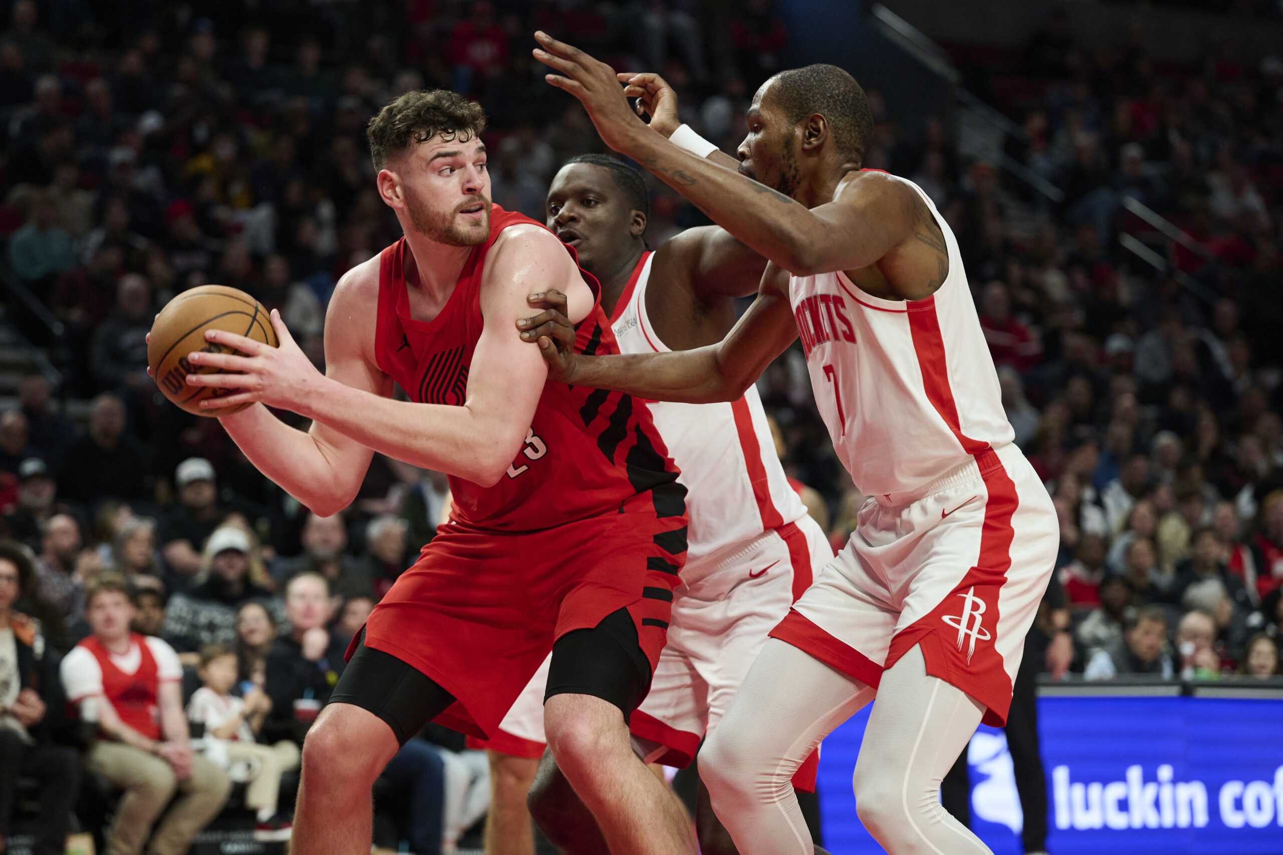Jan 9, 2026; Portland, Oregon, USA; Portland Trail Blazers center Donovan Clingan (23) looks to pass the ball during the second half against Houston Rockets center Clint Capela (30) and forward Kevin Durant (7) at Moda Center. Mandatory Credit: Troy Wayrynen-Imagn Images