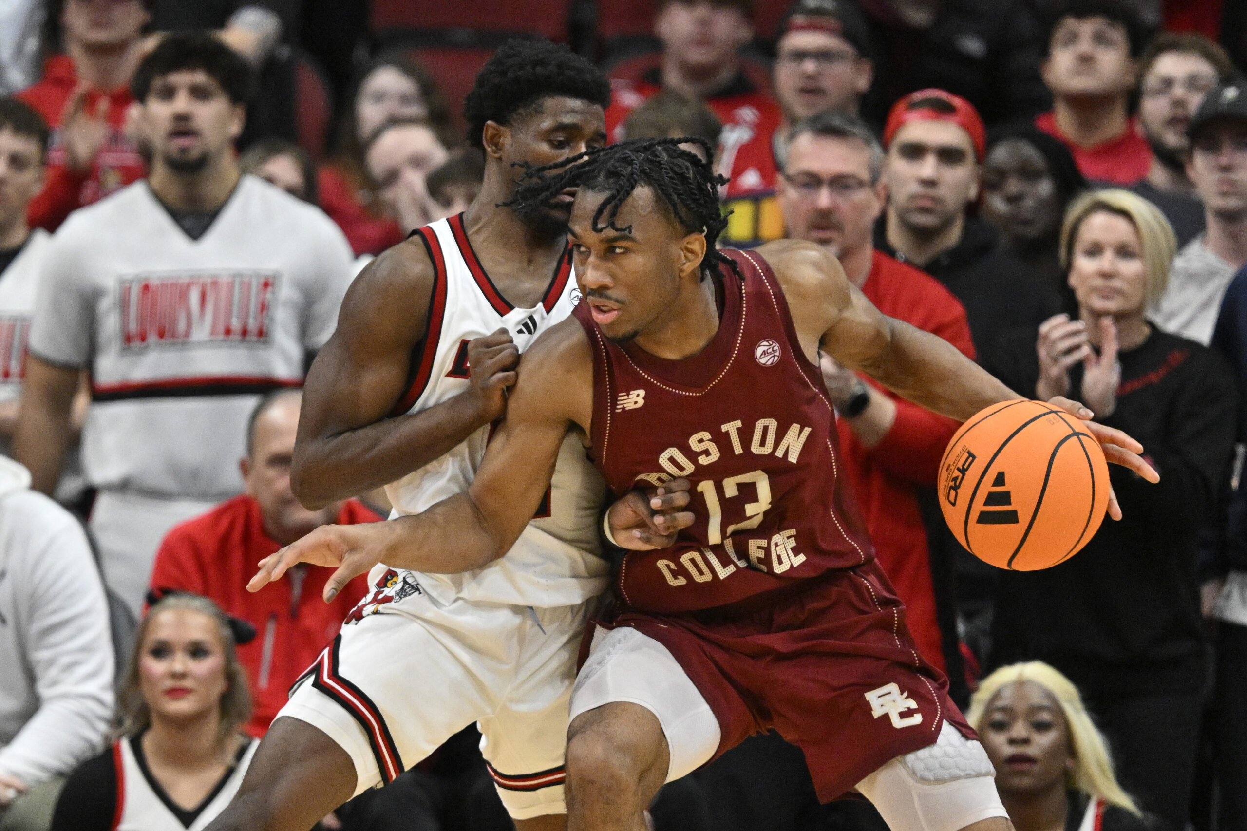 Jan 10, 2026; Louisville, Kentucky, USA;  Boston College Eagles guard Donald Hand Jr. (13) posts up against Louisville Cardinals guard Kobe Rodgers (11) during the second half at KFC Yum! Center.  Mandatory Credit: Jamie Rhodes-Imagn Images