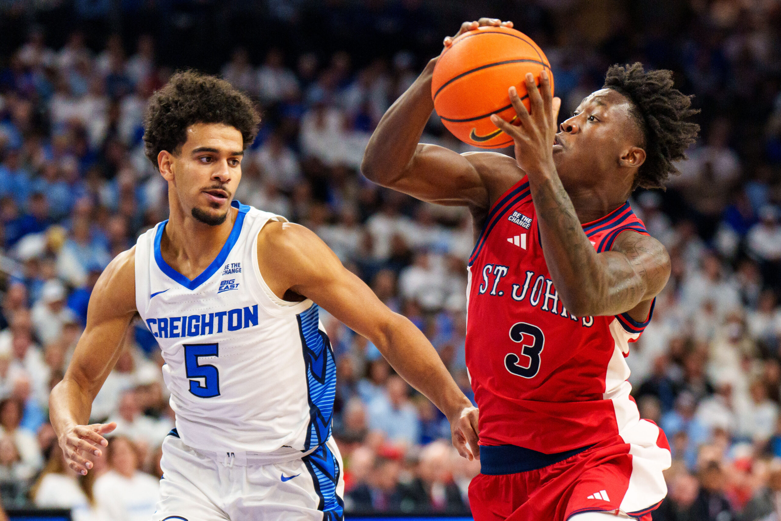Jan 10, 2026; Omaha, Nebraska, USA; St. John's Red Storm guard Joson Sanon (3) drives to the hoop against Creighton Bluejays guard Nik Graves (5) during the first half at CHI Health Center Omaha. Mandatory Credit: Dylan Widger-Imagn Images