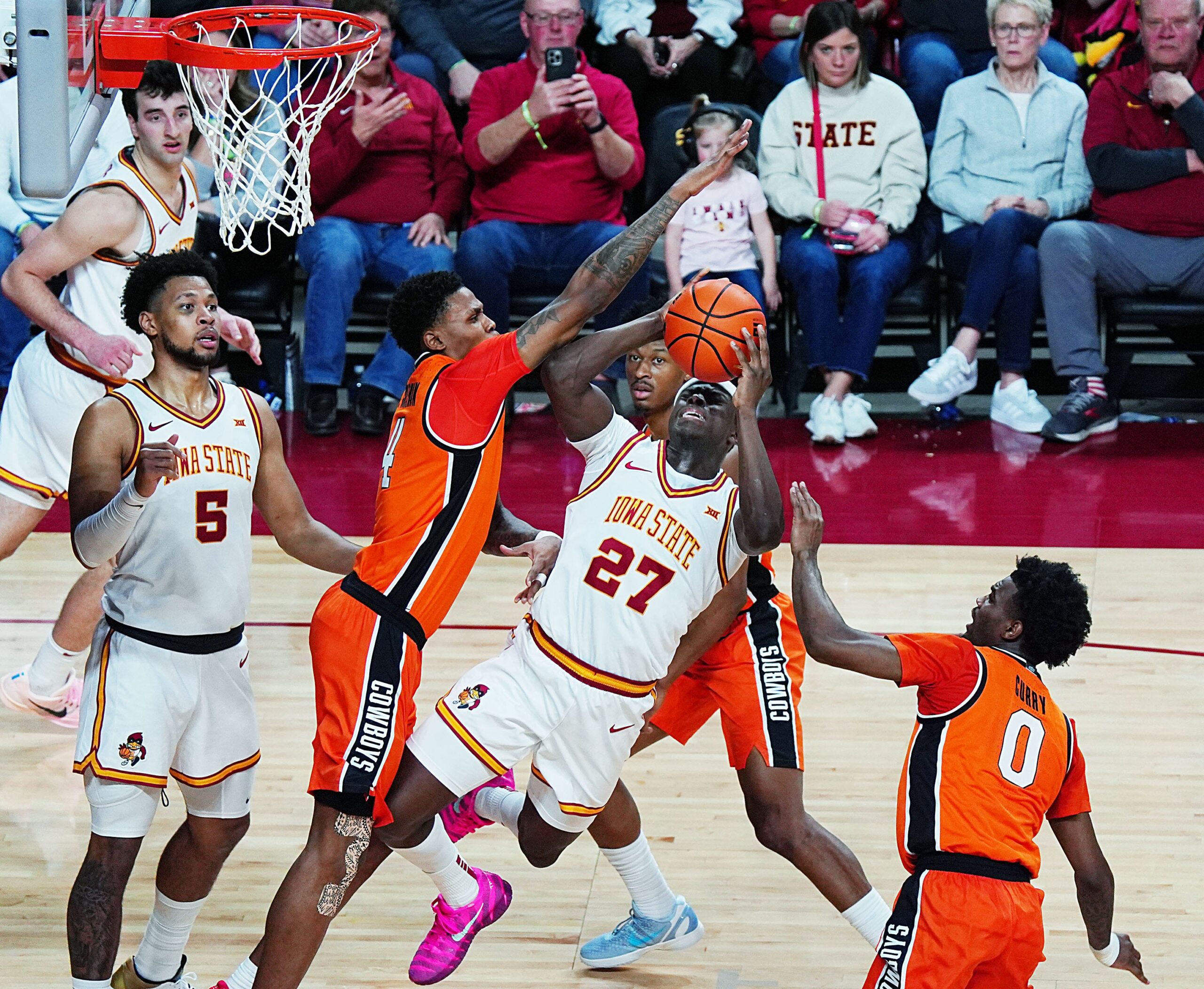 Iowa State Cyclones forward Killyan Toure (27) shoots the ball as Oklahoma State Cowboys guard Christian Coleman (4) defends during the second half in the Big-12 men’s basketball on Jan. 10, 2026, at Hilton Coliseum in Ames, Iowa.
