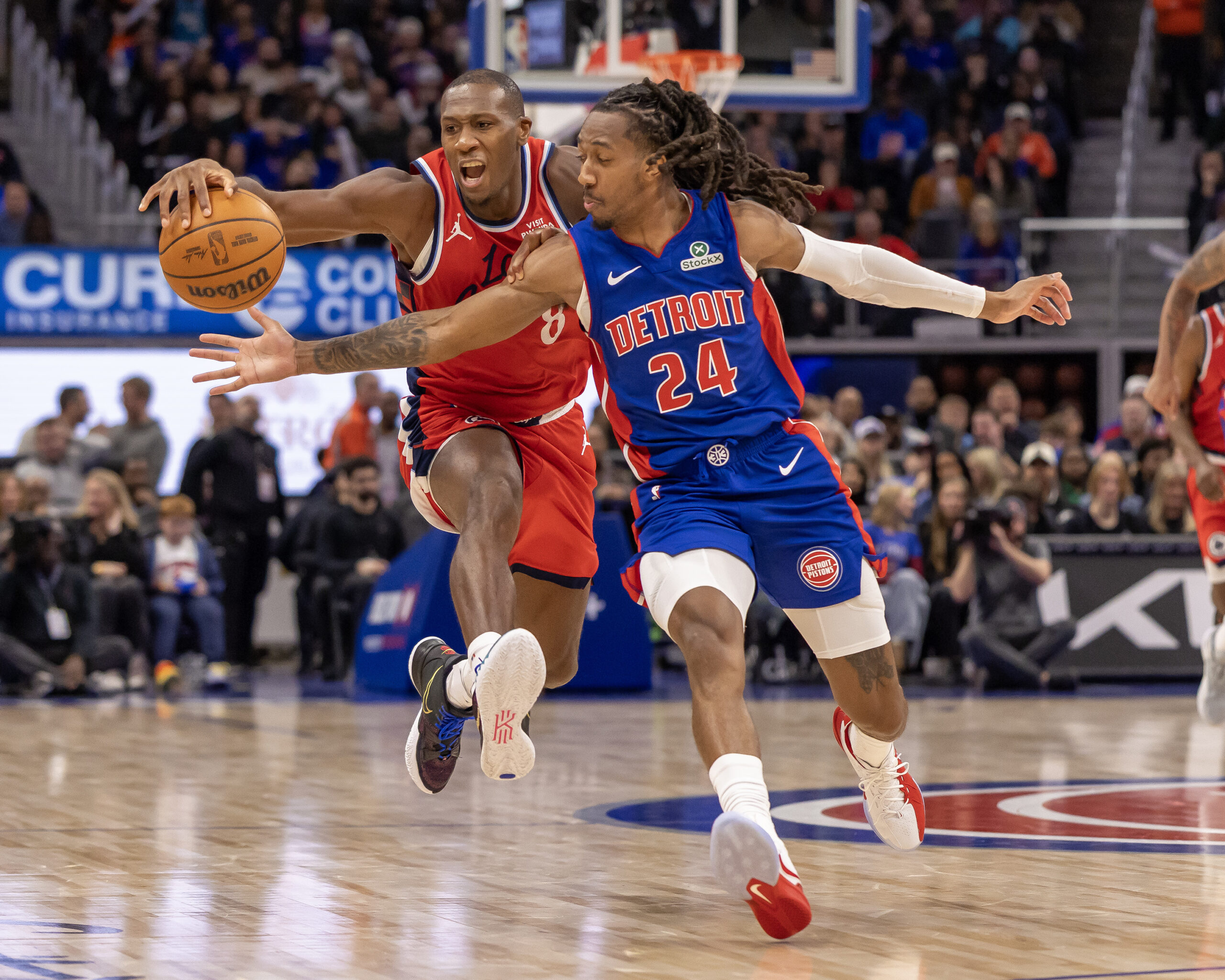 Jan 10, 2026; Detroit, Michigan, USA; Detroit Pistons guard Daniss Jenkins (24) defends against LA Clippers guard Kris Dunn (8) during the second half at Little Caesars Arena. Mandatory Credit: David Reginek-Imagn Images