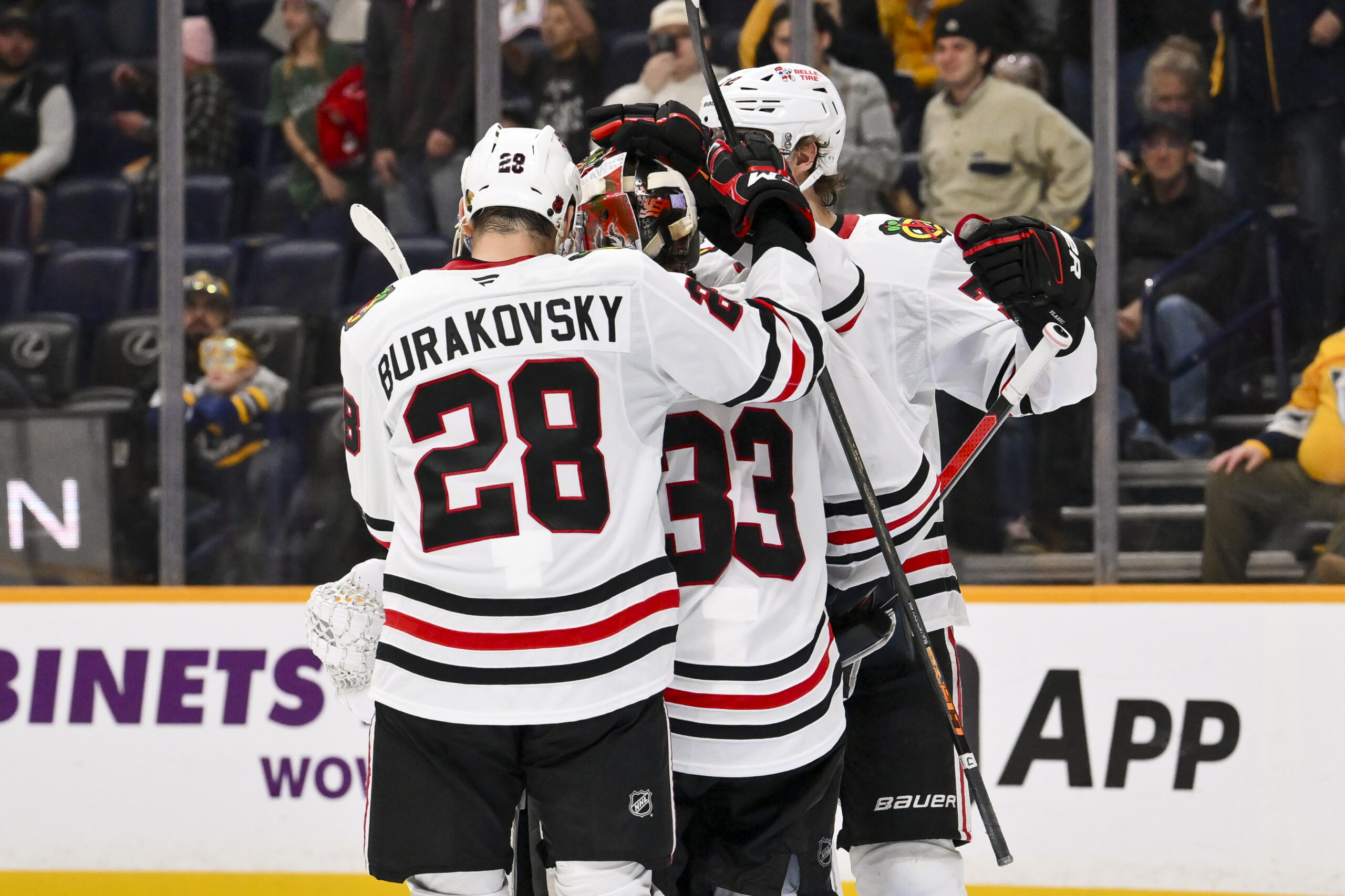 Jan 10, 2026; Nashville, Tennessee, USA;  Chicago Blackhawks goaltender Drew Commesso (33) celebrates the win with his teammates against the Nashville Predators during the third period at Bridgestone Arena. Mandatory Credit: Steve Roberts-Imagn Images