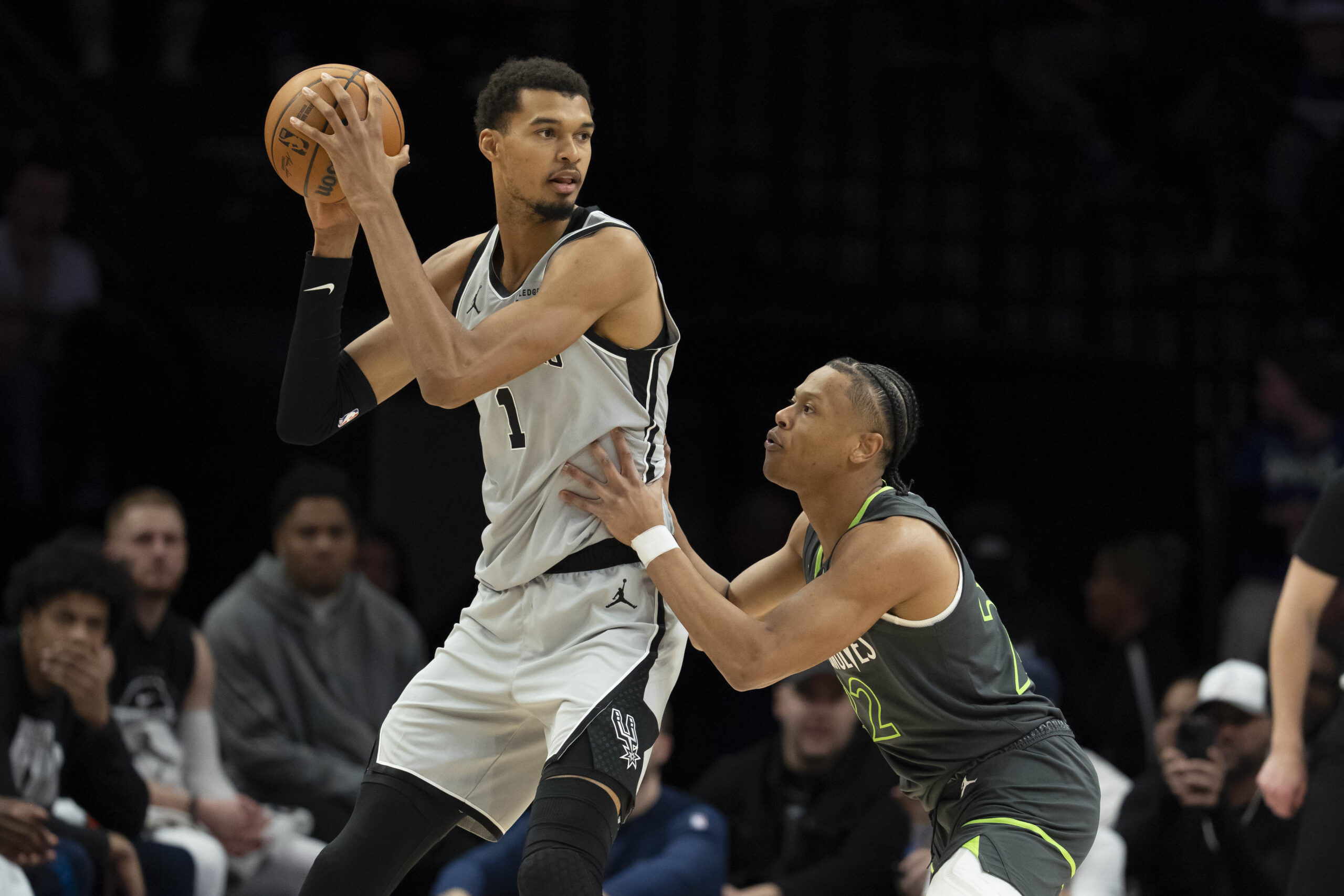 Jan 11, 2026; Minneapolis, Minnesota, USA; San Antonio Spurs forward Victor Wembanyama (1) holds the ball as Minnesota Timberwolves guard Jaylen Clark (22) plays defense in the second half at Target Center. Mandatory Credit: Jesse Johnson-Imagn Images