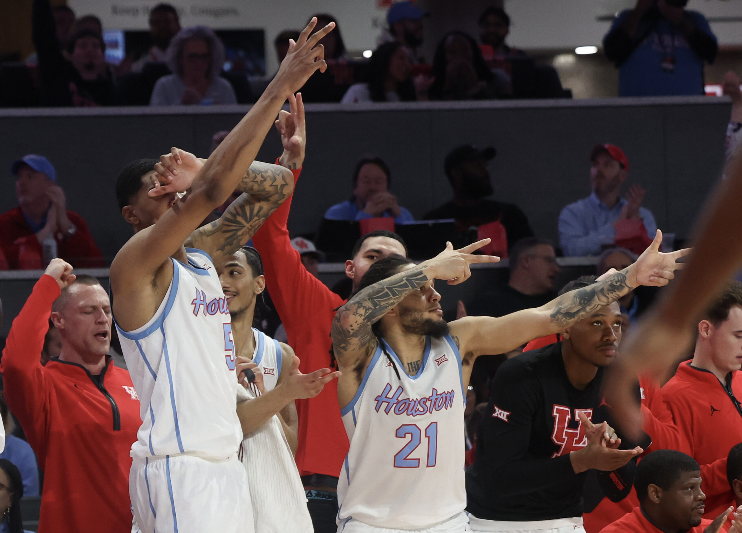 Jan 13, 2026; Houston, Texas, USA; Houston Cougars center Chris Cenac Jr. (5) and Houston Cougars guard Emanuel Sharp (21) celebrates a Cougars three point basket against the West Virginia Mountaineers in the second half at Fertitta Center. Mandatory Credit: Thomas Shea-Imagn Images