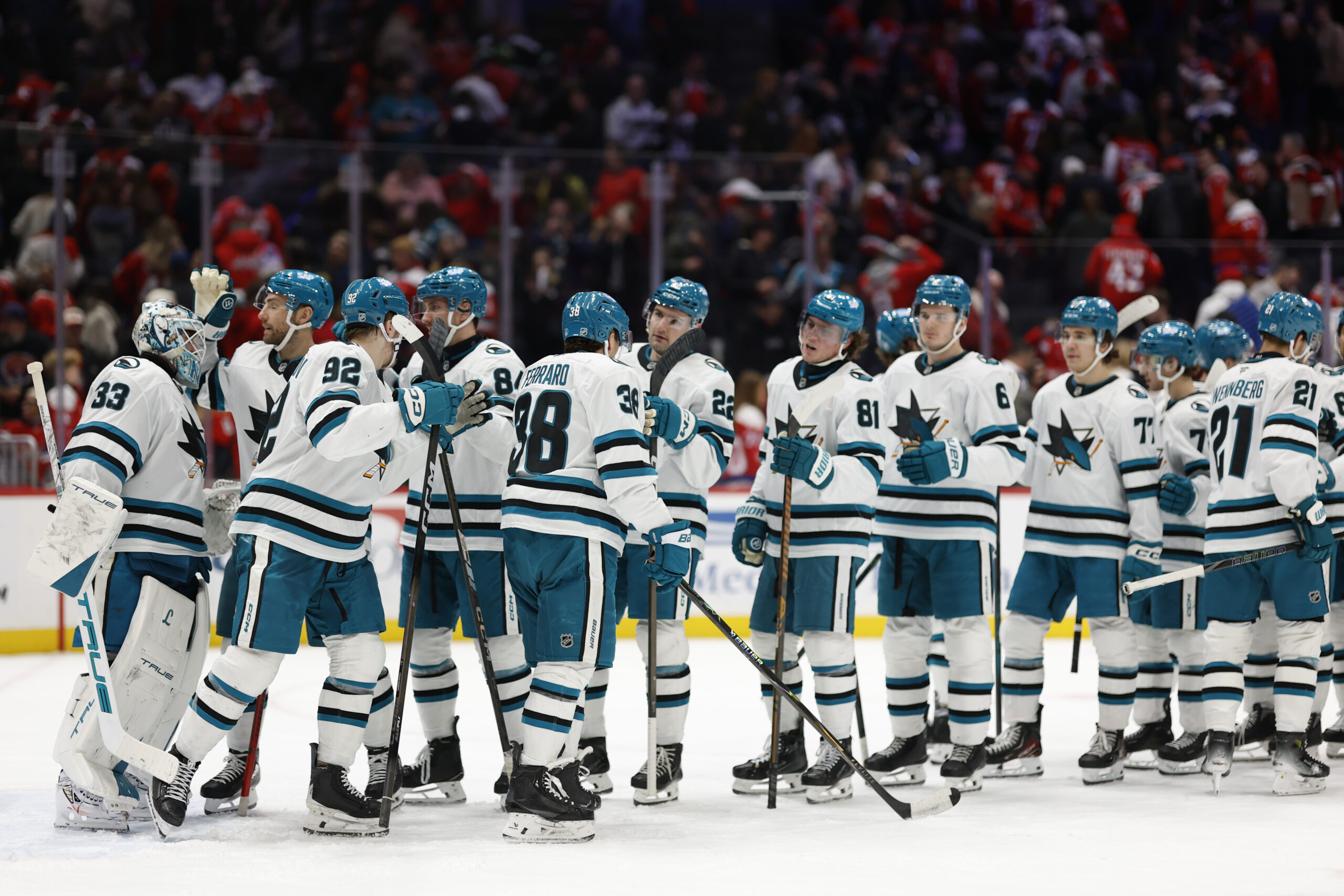 Jan 15, 2026; Washington, District of Columbia, USA; San Jose Sharks goaltender Alex Nedeljkovic (33) celebrates with teammates after their game against the Washington Capitals at Capital One Arena. Mandatory Credit: Geoff Burke-Imagn Images