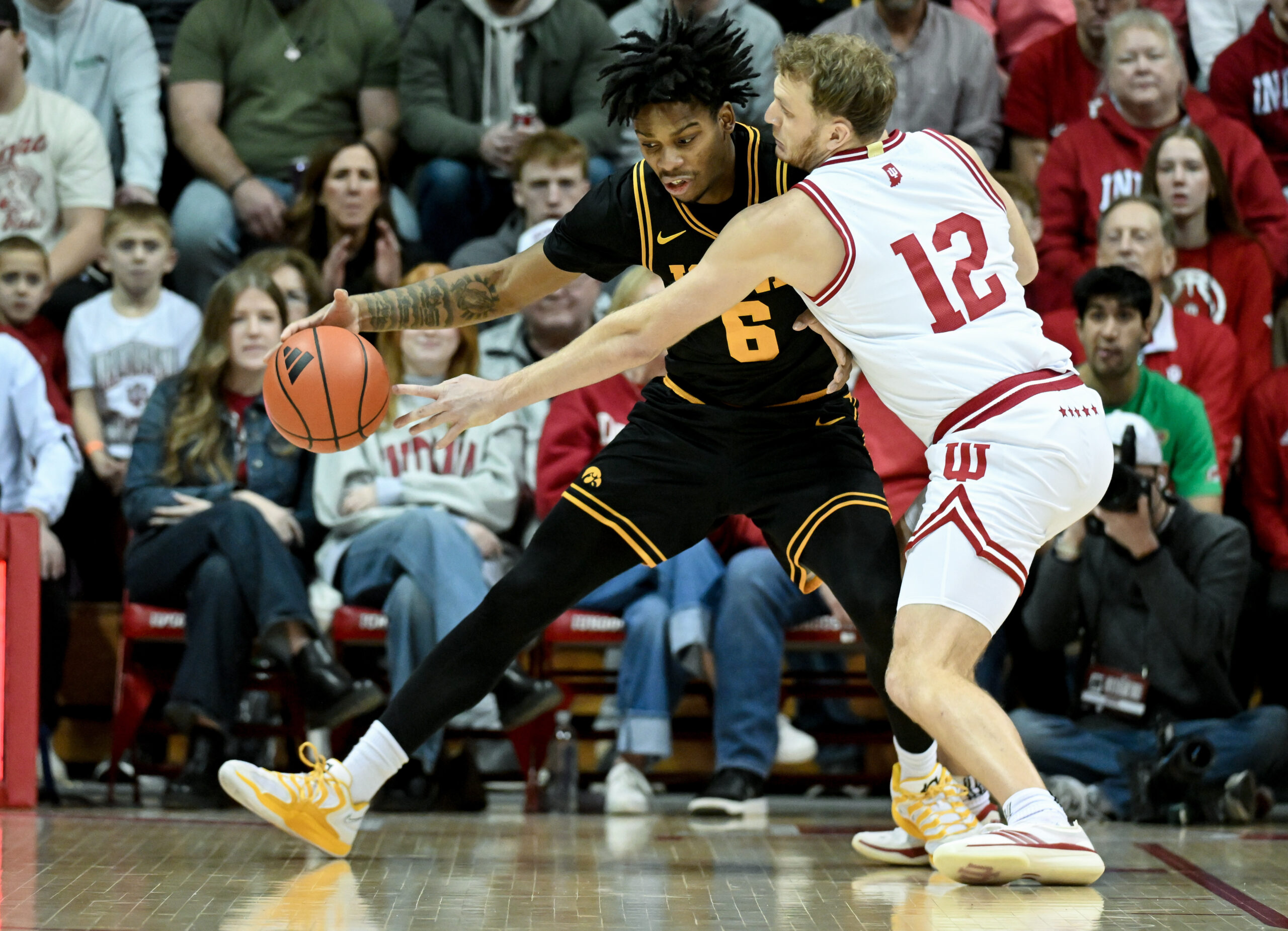 Jan 17, 2026; Bloomington, Indiana, USA; Indiana Hoosiers forward Tucker DeVries (12) knocks the ball away from Iowa Hawkeyes guard Tavion Banks (6) during the first half at Simon Skjodt Assembly Hall. Mandatory Credit: Robert Goddin-Imagn Images