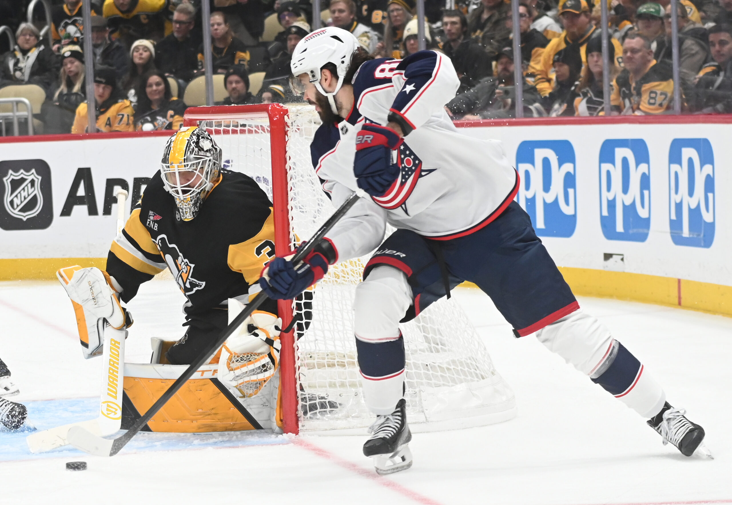 Jan 17, 2026; Pittsburgh, Pennsylvania, USA;  Columbus Blue Jackets right wing Kirill Marchenko (86) pressures Pittsburgh Penguins goalie Arturs Silovs (37) during the second period at PPG Paints Arena. Mandatory Credit: Philip G. Pavely-Imagn Images
