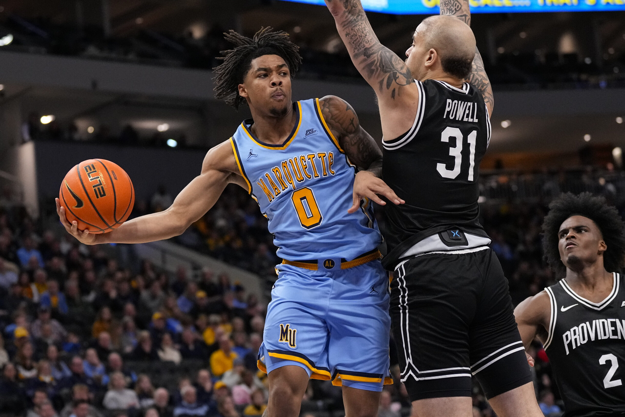 Jan 19, 2026; Milwaukee, Wisconsin, USA;  Marquette Golden Eagles guard Nigel James Jr. (0) passes the ball around Providence Friars forward Duncan Powell (31) during the second half at Fiserv Forum. Mandatory Credit: Jeff Hanisch-Imagn Images