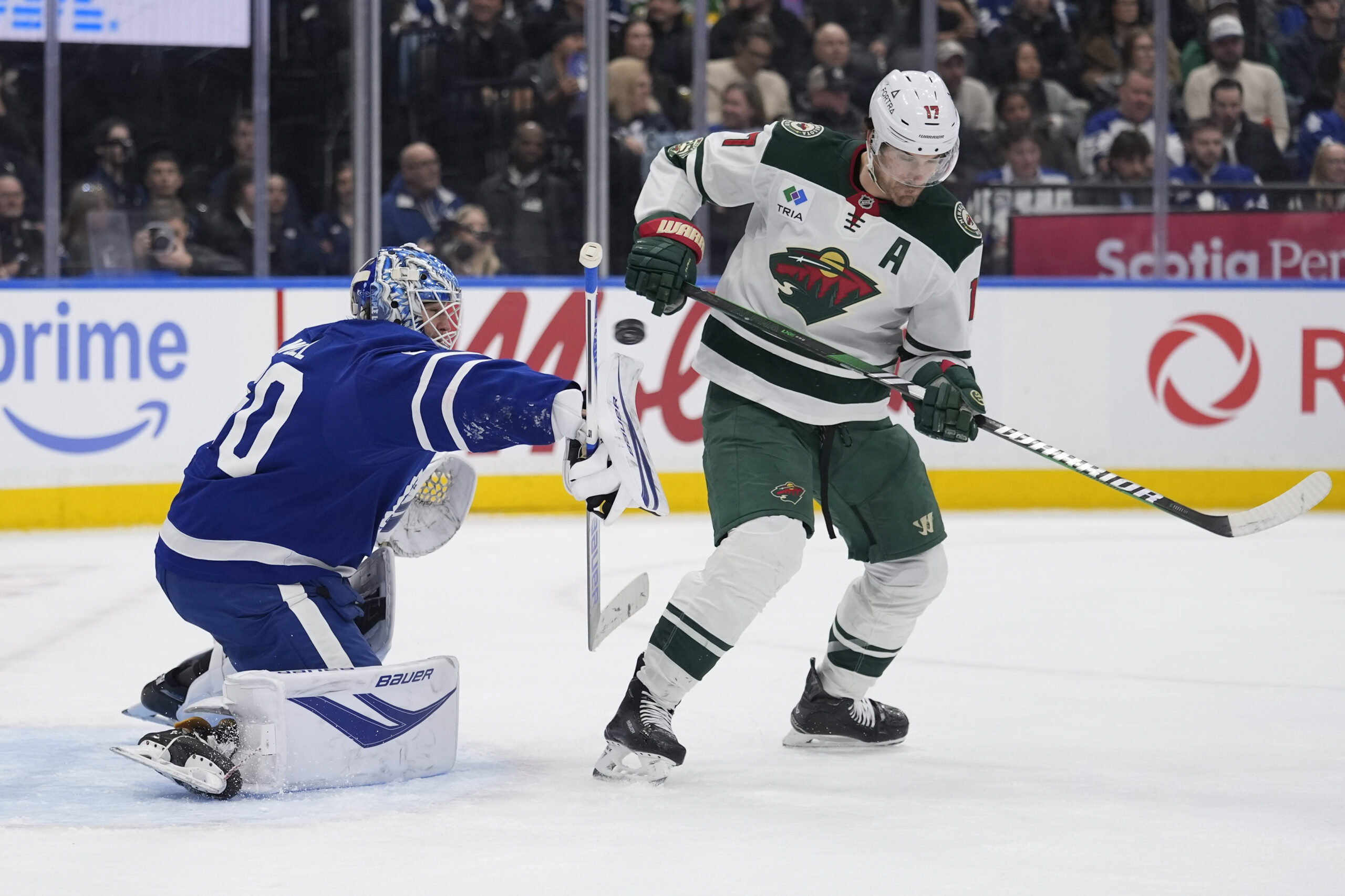 Jan 19, 2026; Toronto, Ontario, CAN; Minnesota Wild forward Marcus Foligno (17) scores his second goal of the game on a deflected shot against Toronto Maple Leafs goaltender Joseph Woll (60) during the second period at Scotiabank Arena. Mandatory Credit: John E. Sokolowski-Imagn Images