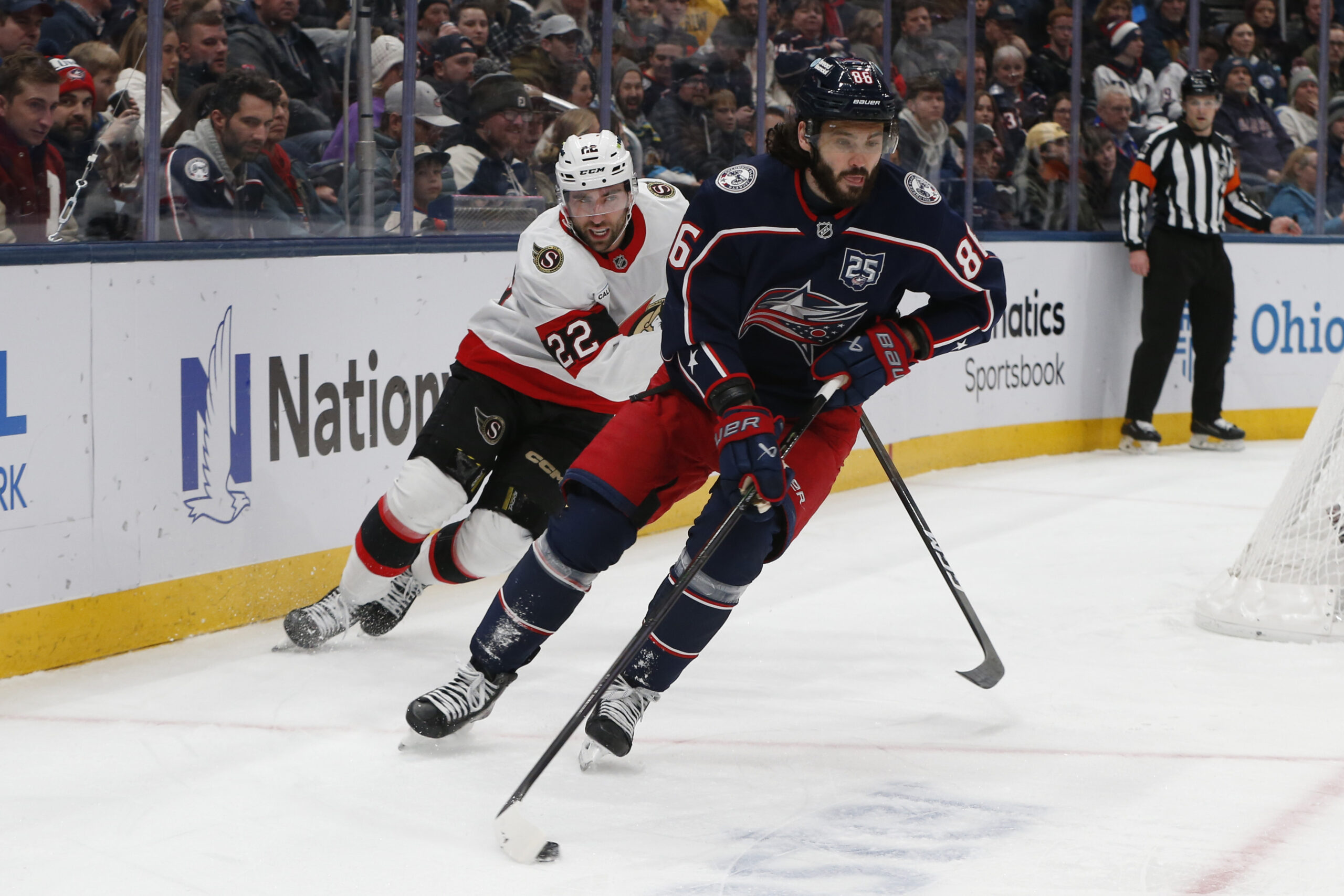 Jan 20, 2026; Columbus, Ohio, USA; Columbus Blue Jackets right wing Kirill Marchenko (86) carries the puck as Ottawa Senators center Michael Amadio (22) trails the play during the first period at Nationwide Arena. Mandatory Credit: Russell LaBounty-Imagn Images