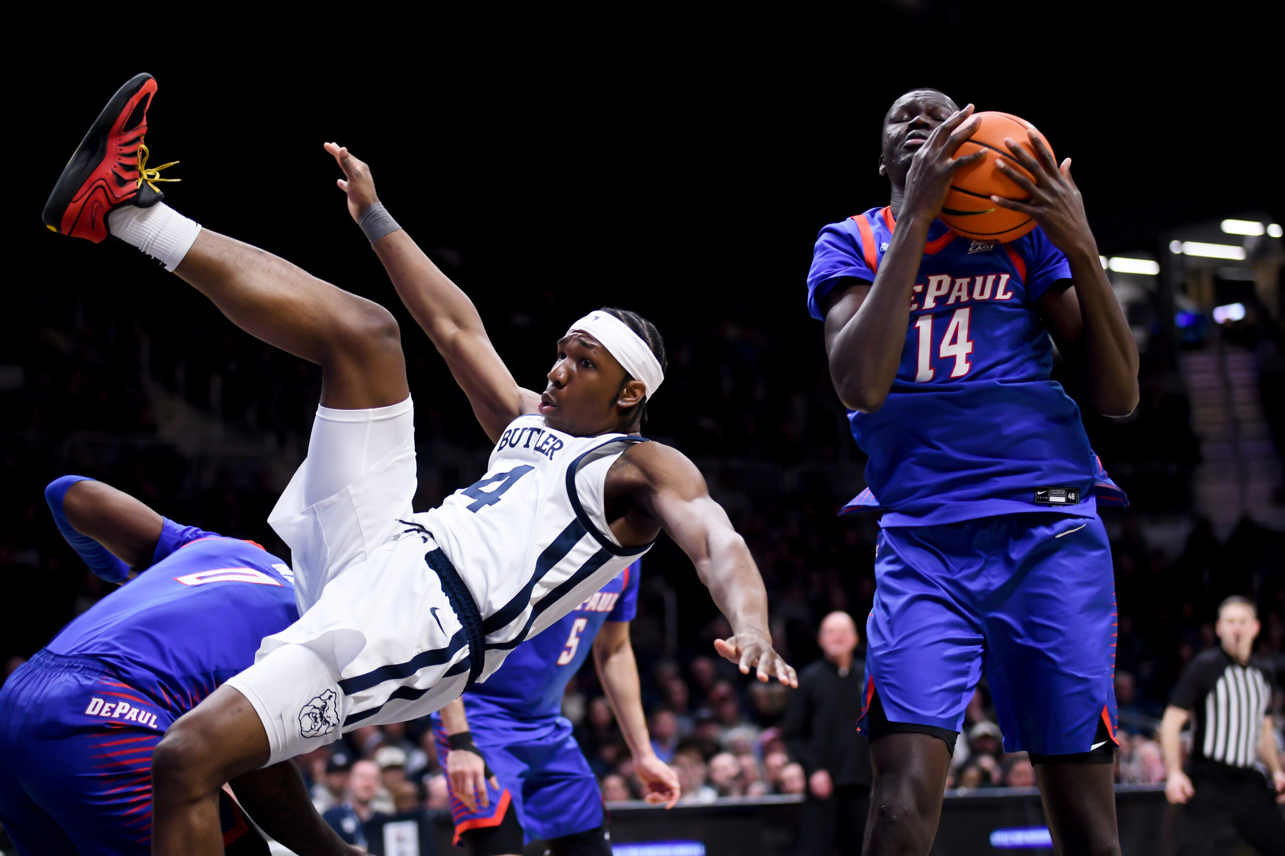 Jan 20, 2026; Indianapolis, Indiana, USA; Butler Bulldogs forward Efeosa Oliogu-Elabor (4) and DePaul Blue Demons center Khaman Maker (14) go for a rebound during the second half at Hinkle Fieldhouse. Mandatory Credit: Robert Goddin-Imagn Images
