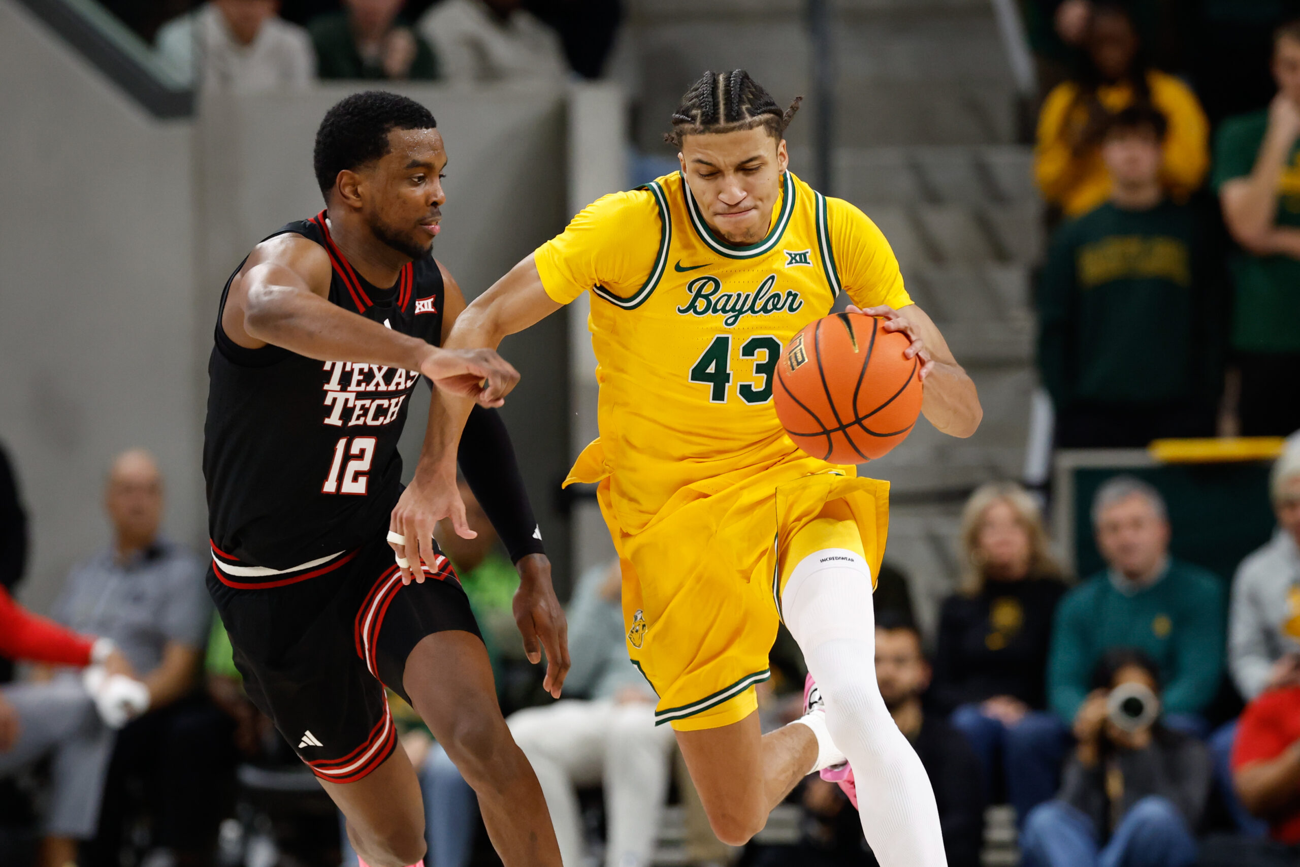 Jan 20, 2026; Waco, Texas, USA; Baylor Bears guard Cameron Carr (43) dribbles the ball upcourt against Texas Tech Red Raiders forward Donovan Atwell (12) during the second half at Paul and Alejandra Foster Pavilion. Mandatory Credit: Chris Jones-Imagn Images